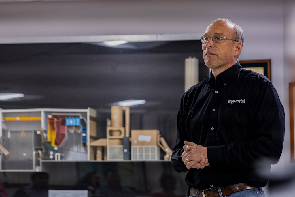 Steve Abe, the facility manager for the Montgomery country resource recovery facility, stands in front of a model of the facility as part of his presentation on Wednesday September 18th. The resource recover facility has been operating since 1995 and holds a contract to operate through 2031, but there is a debate about closing the facility due to environmental and cost concerns.