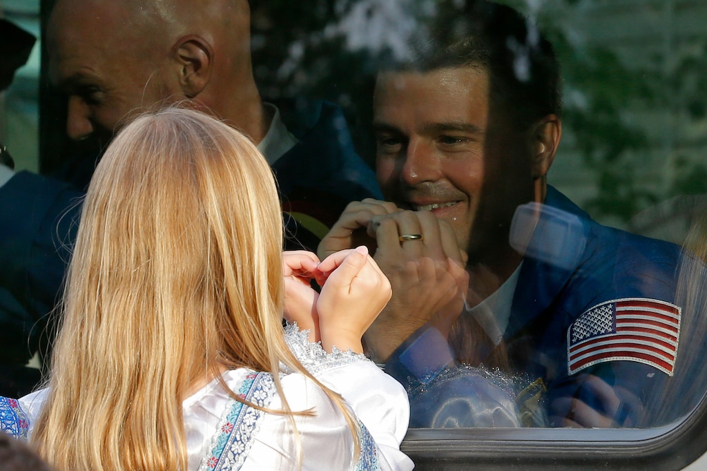 NASA astronaut Reid Wiseman, crew member of the mission to the International Space Station, ISS, gestures with his daughter, from a bus as they leave from a hotel prior the launch of Soyuz-FG rocket at the Russian leased Baikonur cosmodrome, Kazakhstan, Wednesday, May 28, 2014.