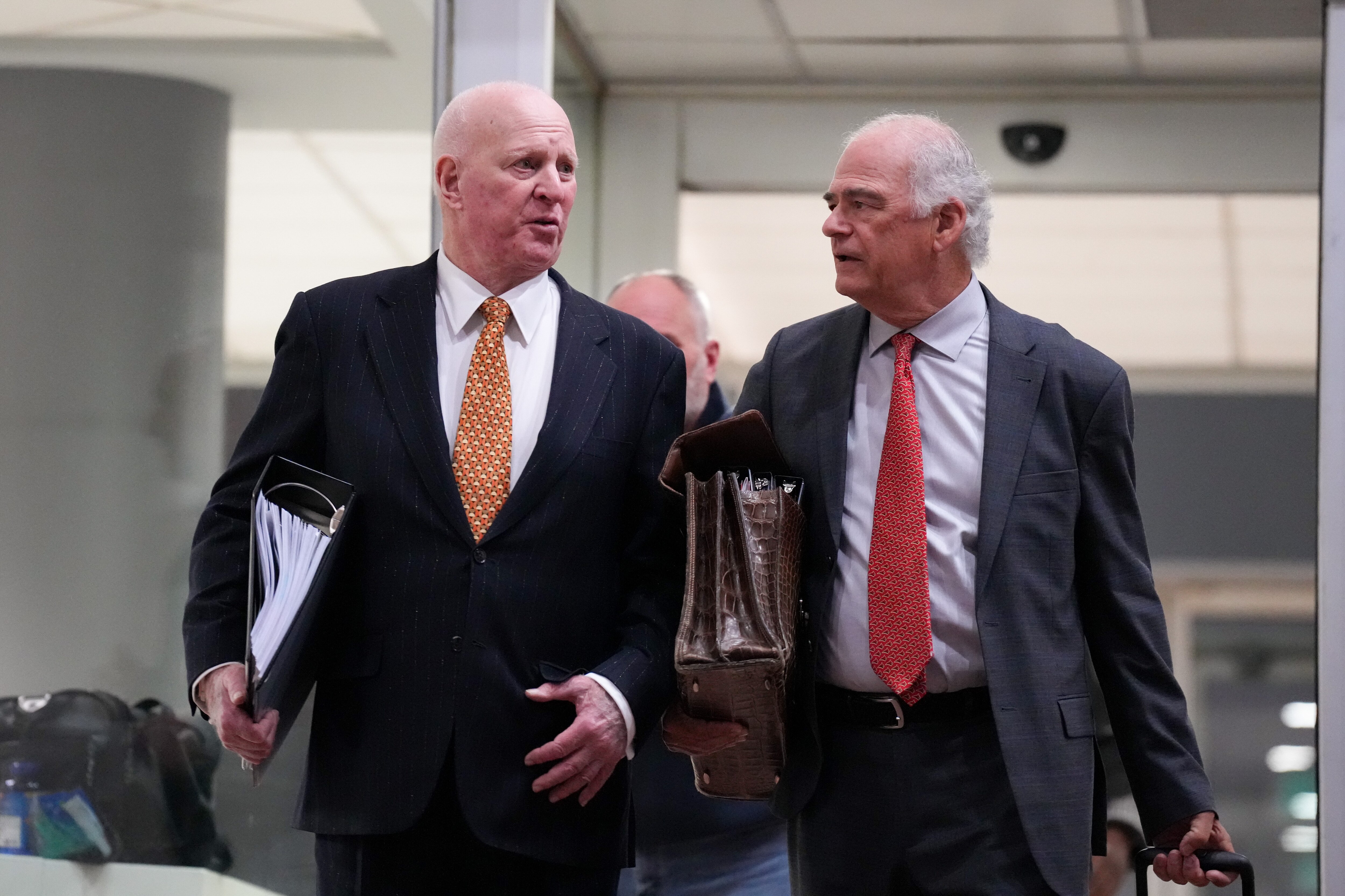 Attorney Stephen L. Snyder, left, leaves the Edward A. Garmatz United States District Courthouse with Gerald Ruter, his standby defense counsel, in Baltimore