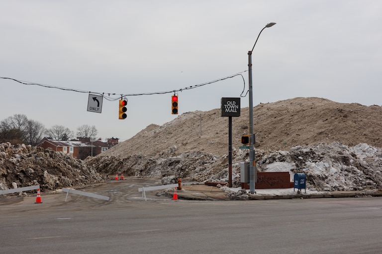 Snow that has been removed from different areas of Baltimore is piled up in the vacant lot next to the Old Town Mall.