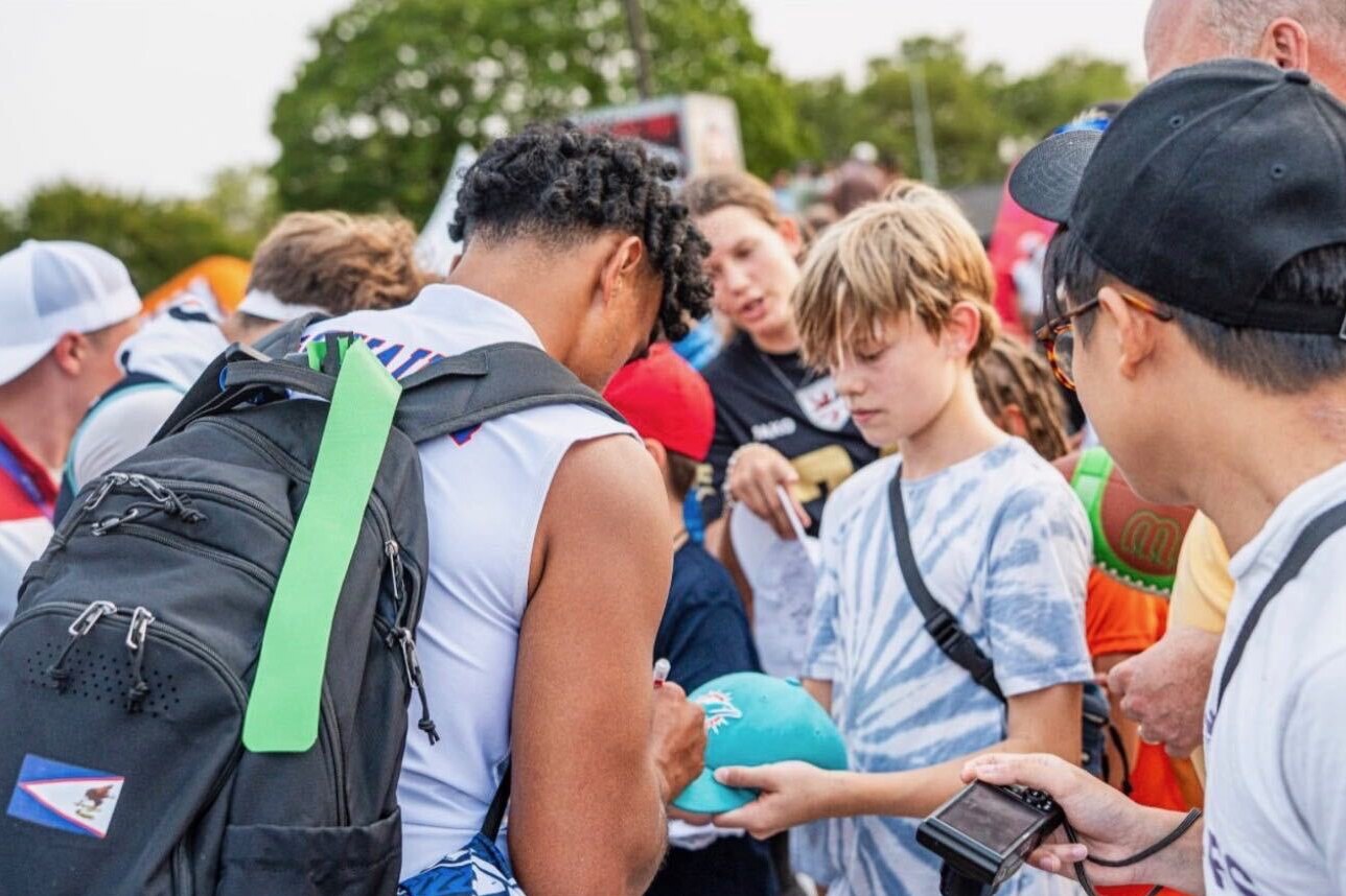 Taulia Tagovailoa signs autographs for fans at the Flag Football World Championships in Dusseldorf, Germany, in August 2026. Tagovailoa, a former Terps quarterback, helped lead American Samoa to a 38-32 upset of Team USA on Aug. 14. American Samoa finished fifth in the the tournament after entering as the lowest-ranked team.