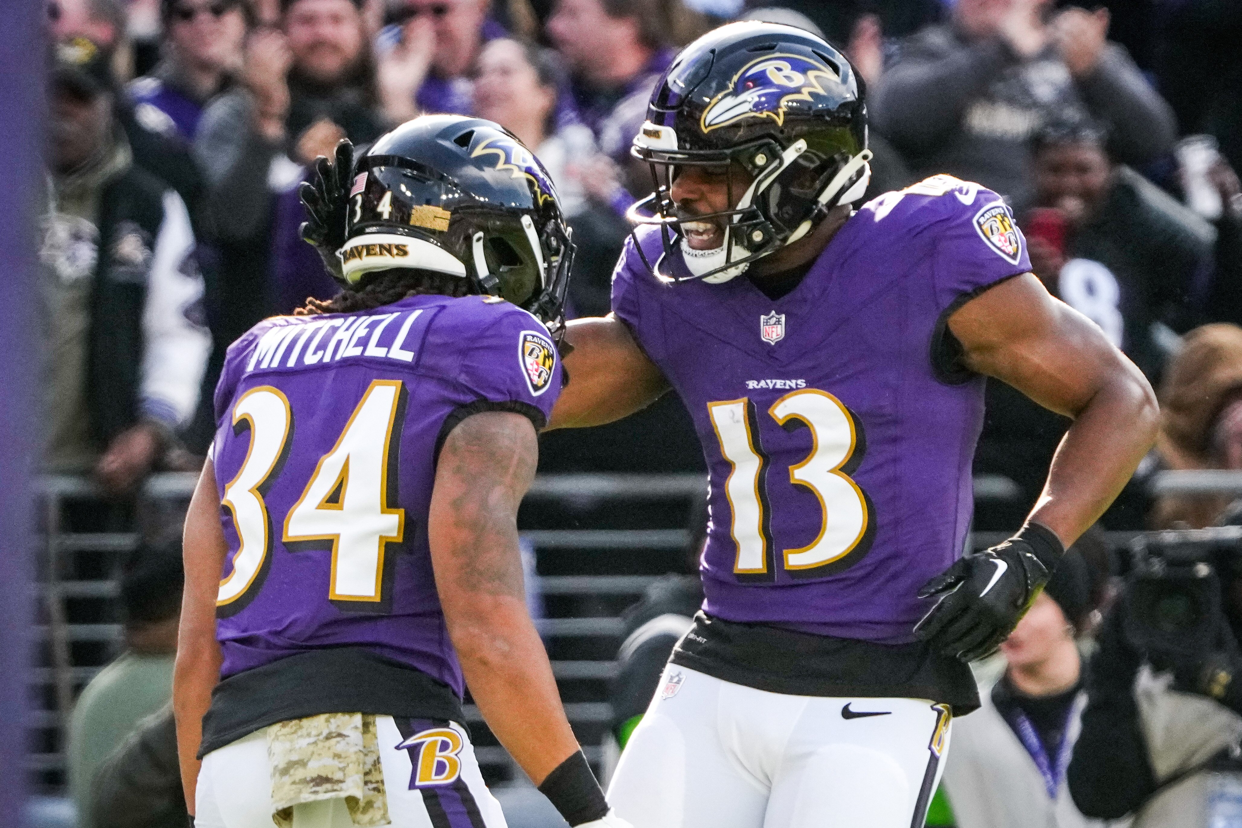 Ravens running back Keaton Mitchell celebrates with wide receiver Devin Duvernay after scoring a touchdown Nov. 12.