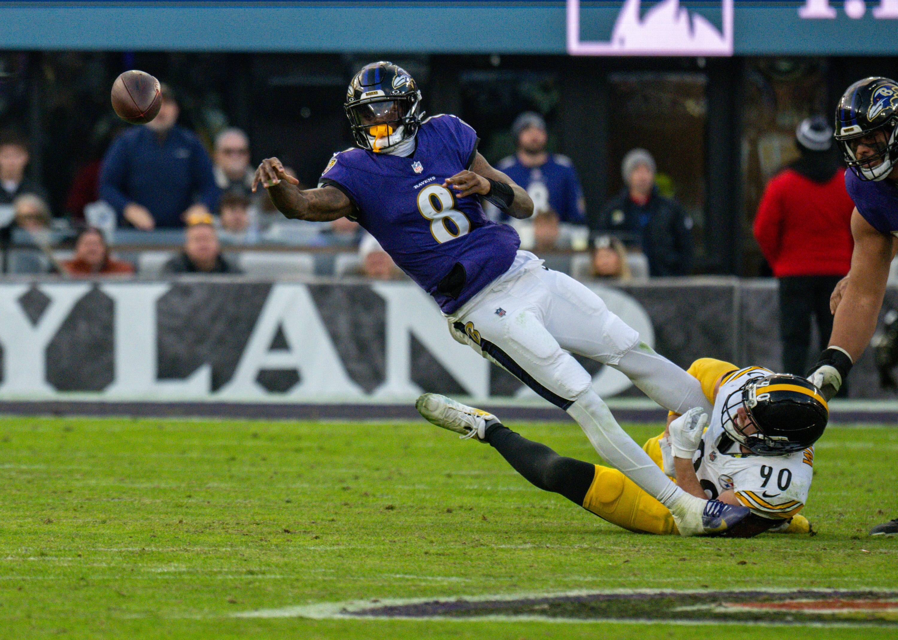 Baltimore Ravens quarterback Lamar Jackson (8) throws an incomplete pass in the fourth quarter as he was being taken down by Pittsburgh Steelers linebacker T.J. Watt (90). The Ravens lost to the Pittsburgh Steelers 27-22 at M&T Bank Stadium.