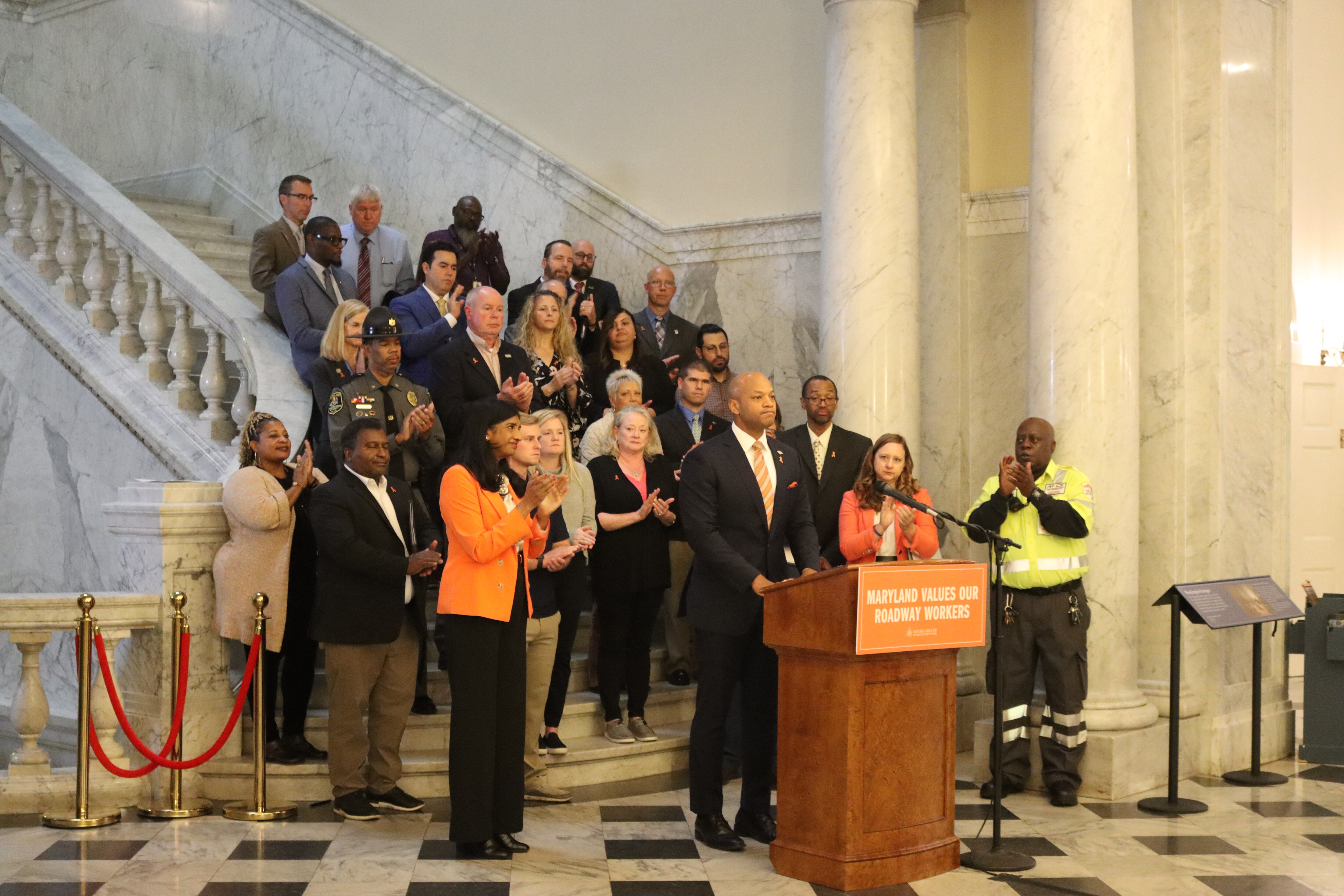 Governor Wes Moore stands in front of members of the Work Zone Safety Group on Nov. 17, 2023. Moore and Lt. Gov. Aruna Miller announced final recommendations to improve work zone safety.