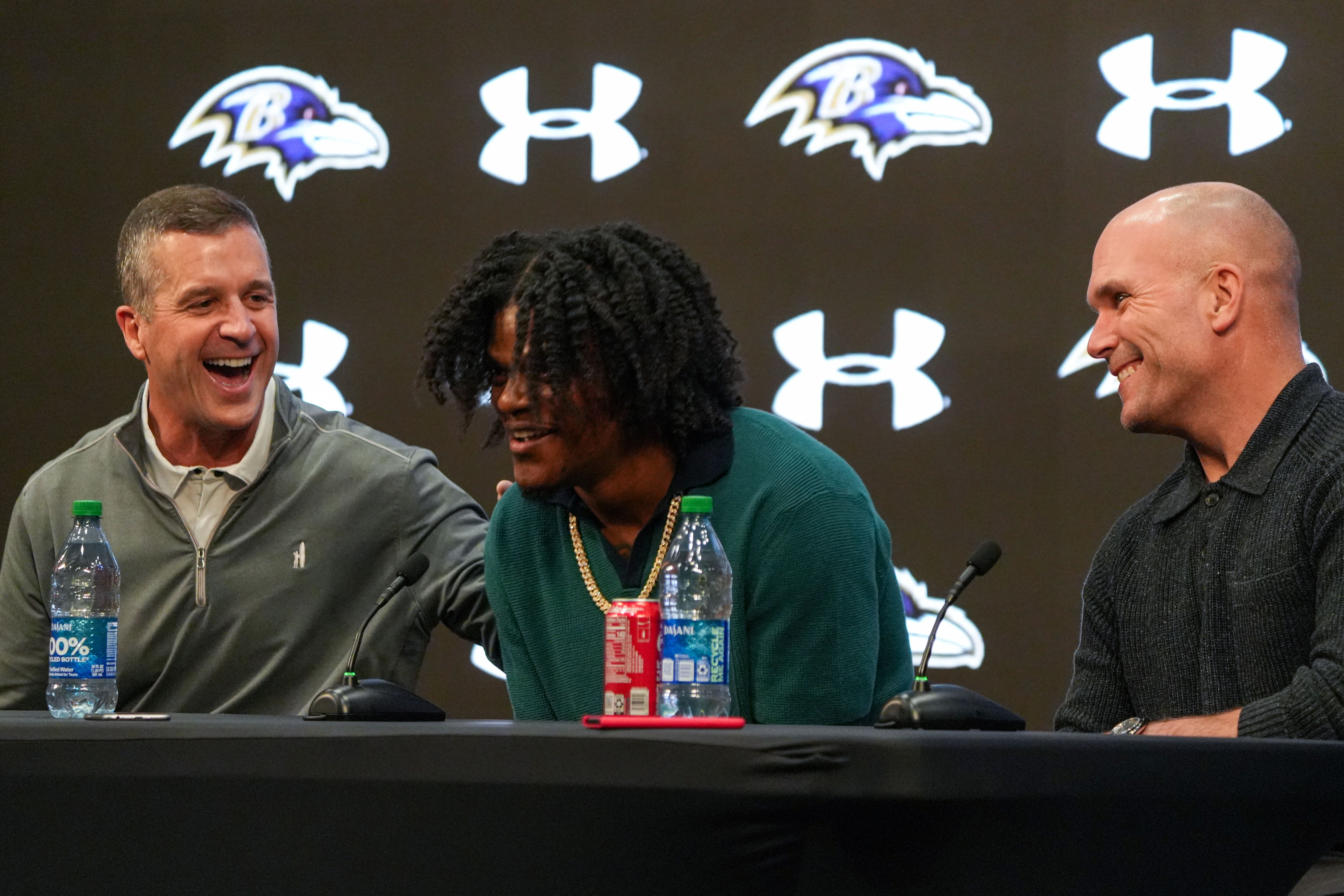 From left: Baltimore Ravens coach John Harbaugh, quarterback Lamar Jackson and general manager Eric DeCosta appear at a press conference after the Ravens signed Jackson to a five-year, $260 million extension.