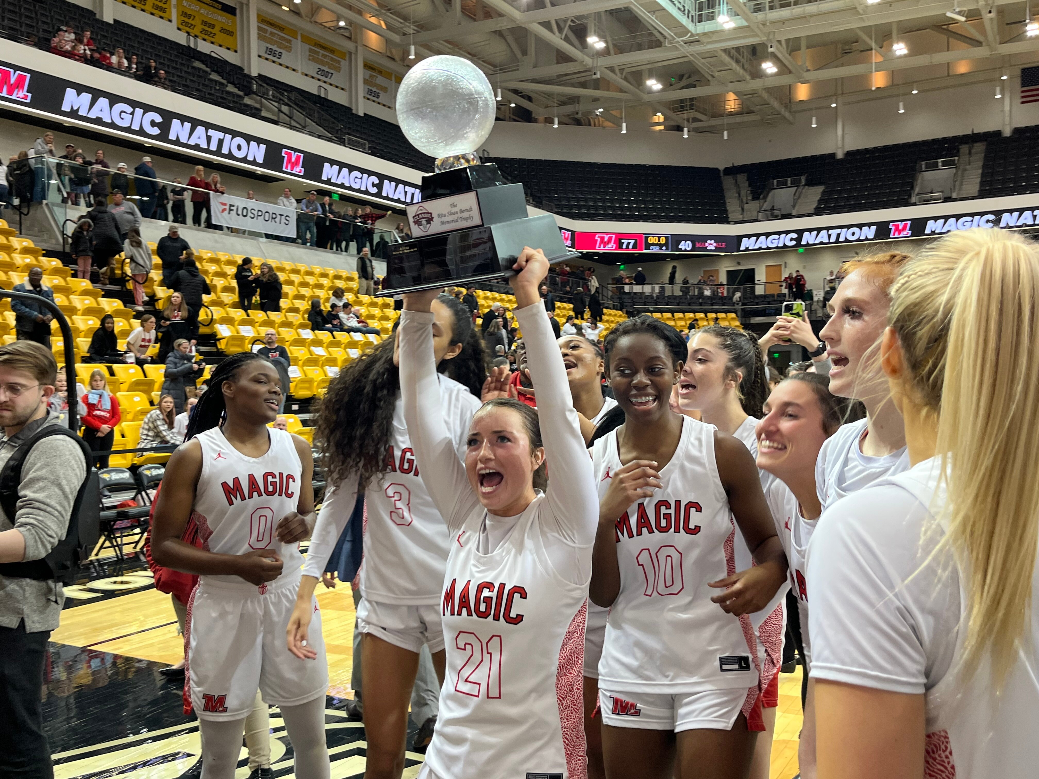 Mercy basketball senior Anabelle Hefner holds up the Rita Sloan Berndt Memorial Trophy following the No. 6 Magic victory over Maryvale Prep in "The Classic" at Towson University's SECU Arena.