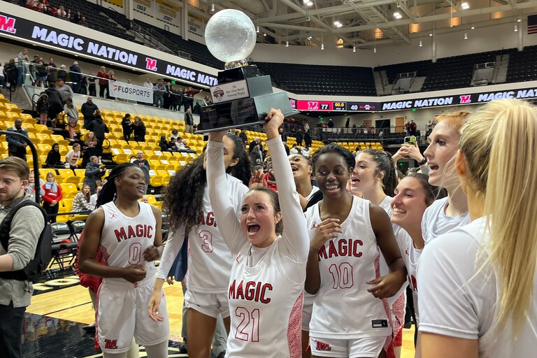 Mercy basketball senior Anabelle Hefner holds up the Rita Sloan Berndt Memorial Trophy following the No. 6 Magic victory over Maryvale Prep in "The Classic" at Towson University's SECU Arena.