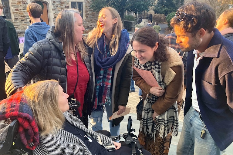 Christine Koniezhny surrounded by colleagues after a Friends School assembly in 2025.