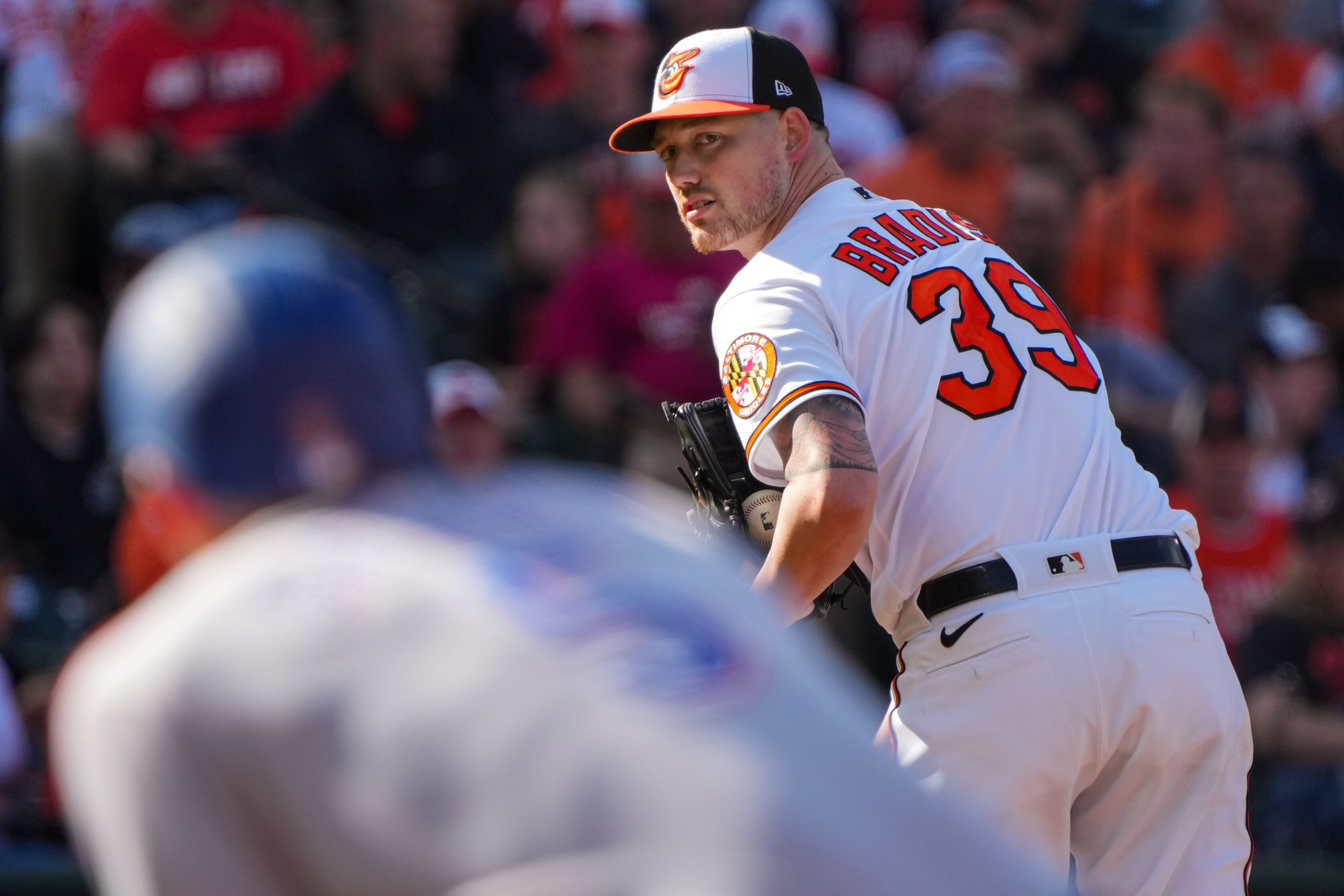Baltimore Orioles starting pitcher Kyle Bradish (39) stares down Texas Rangers shortstop Corey Seager (5) at first base during game one of the American League Divisional Series at Camden Yards on Saturday, October 7, 2023.