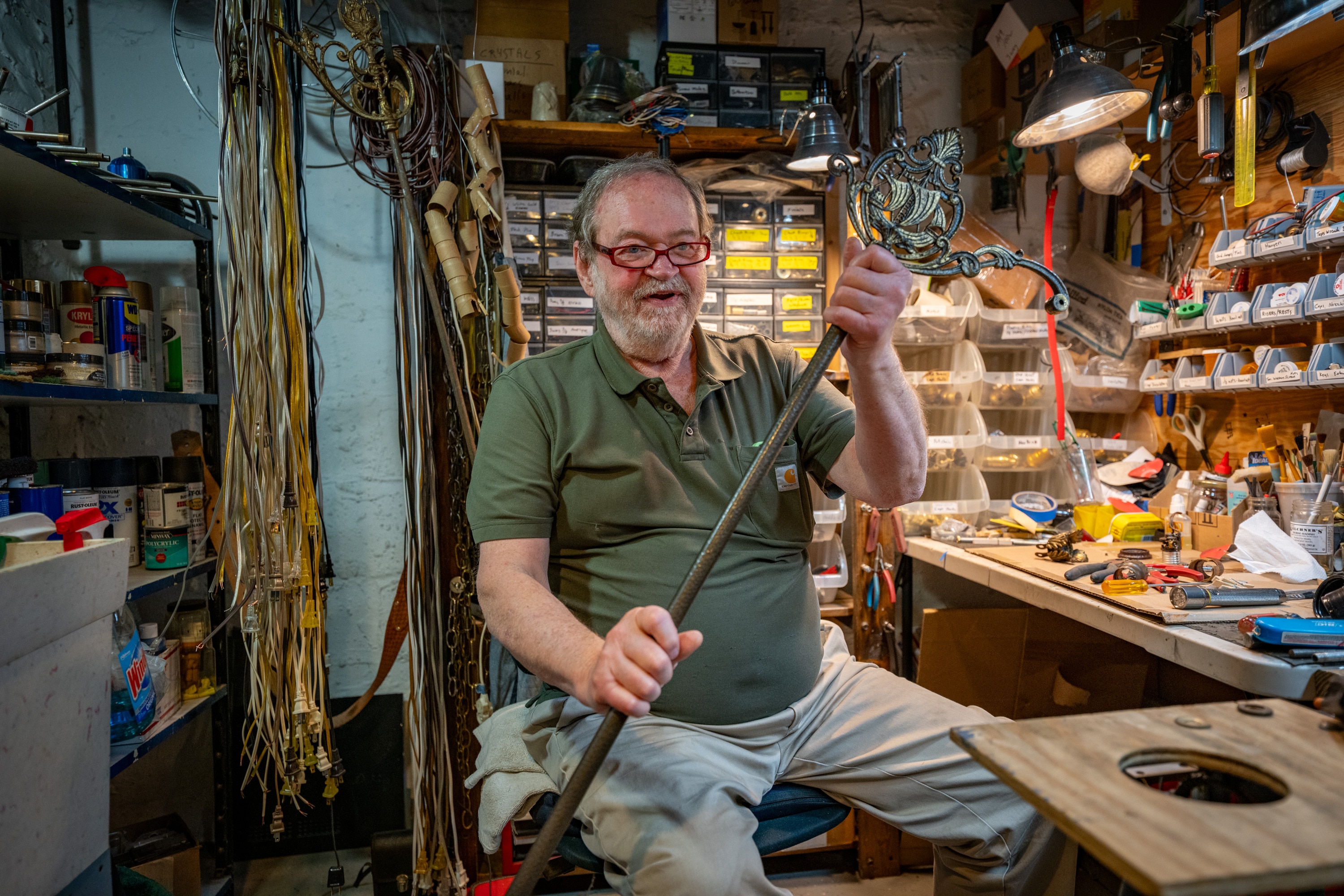 Gary Black, a retired sound engineer, repairs a lamp from the 1930s in his basement workshop.