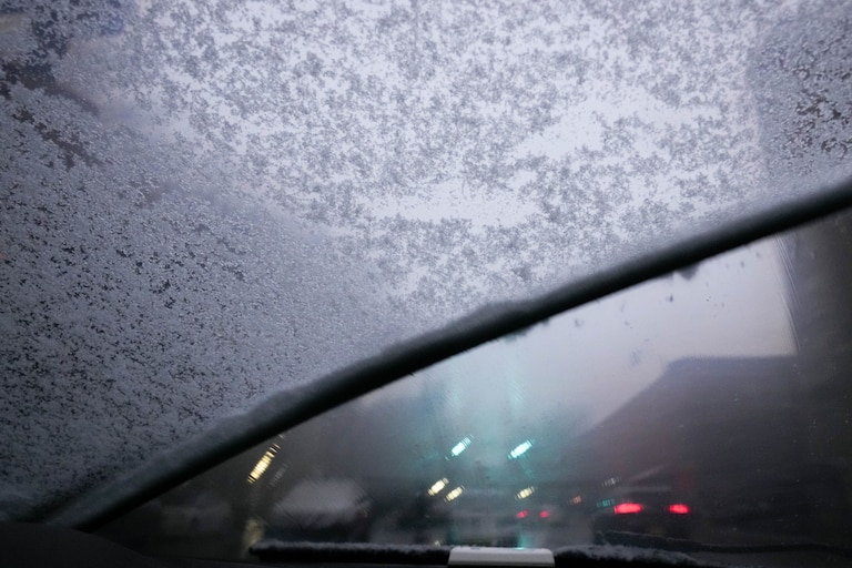 Windshield wipers brush aside a layer of ice that collected on a snowy evening in Baltimore, Md. on Tuesday, February 11, 2025.