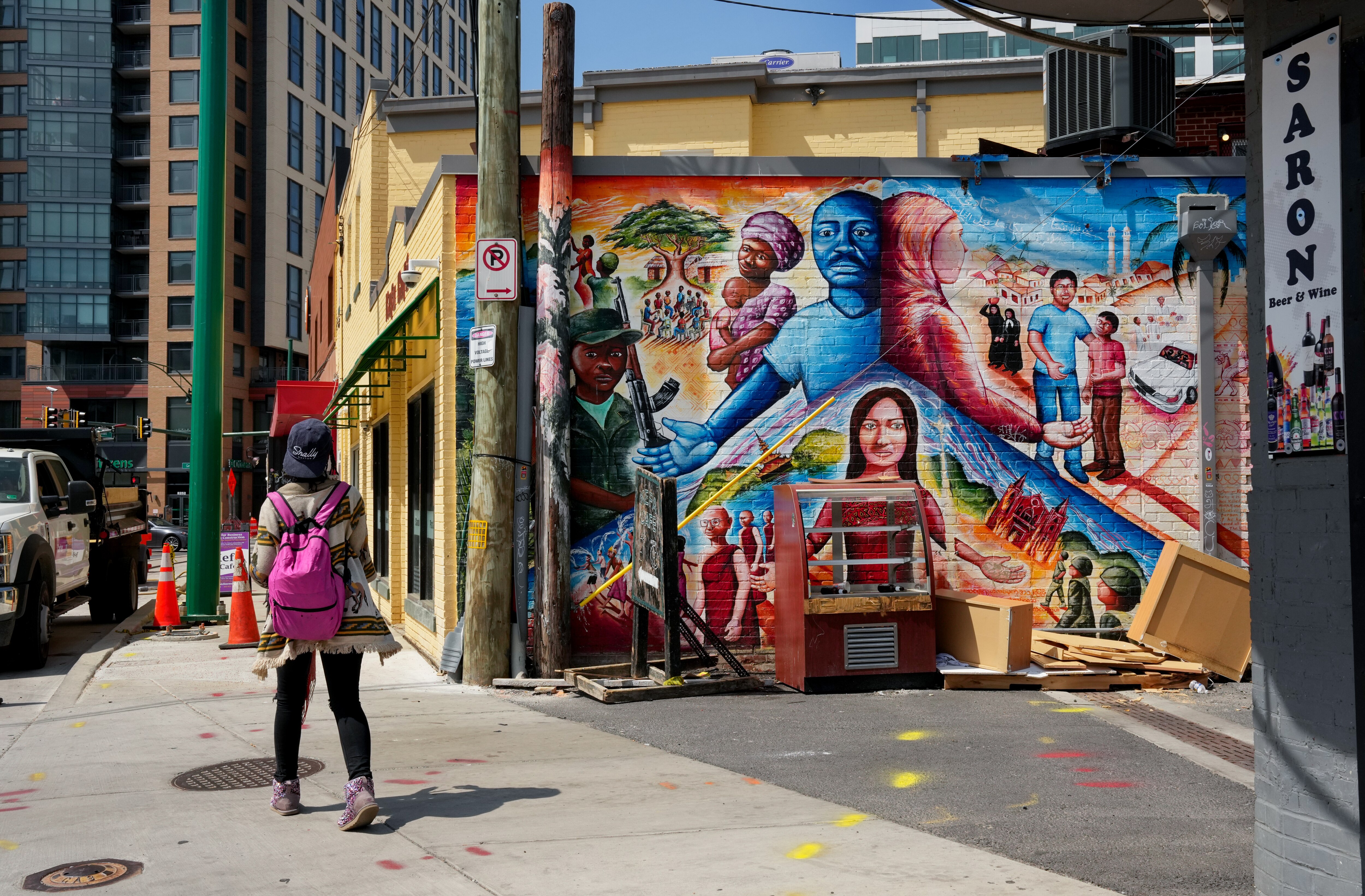 A pedestrian walks past a colorful mural near downtown Silver Spring, Maryland, U.S.