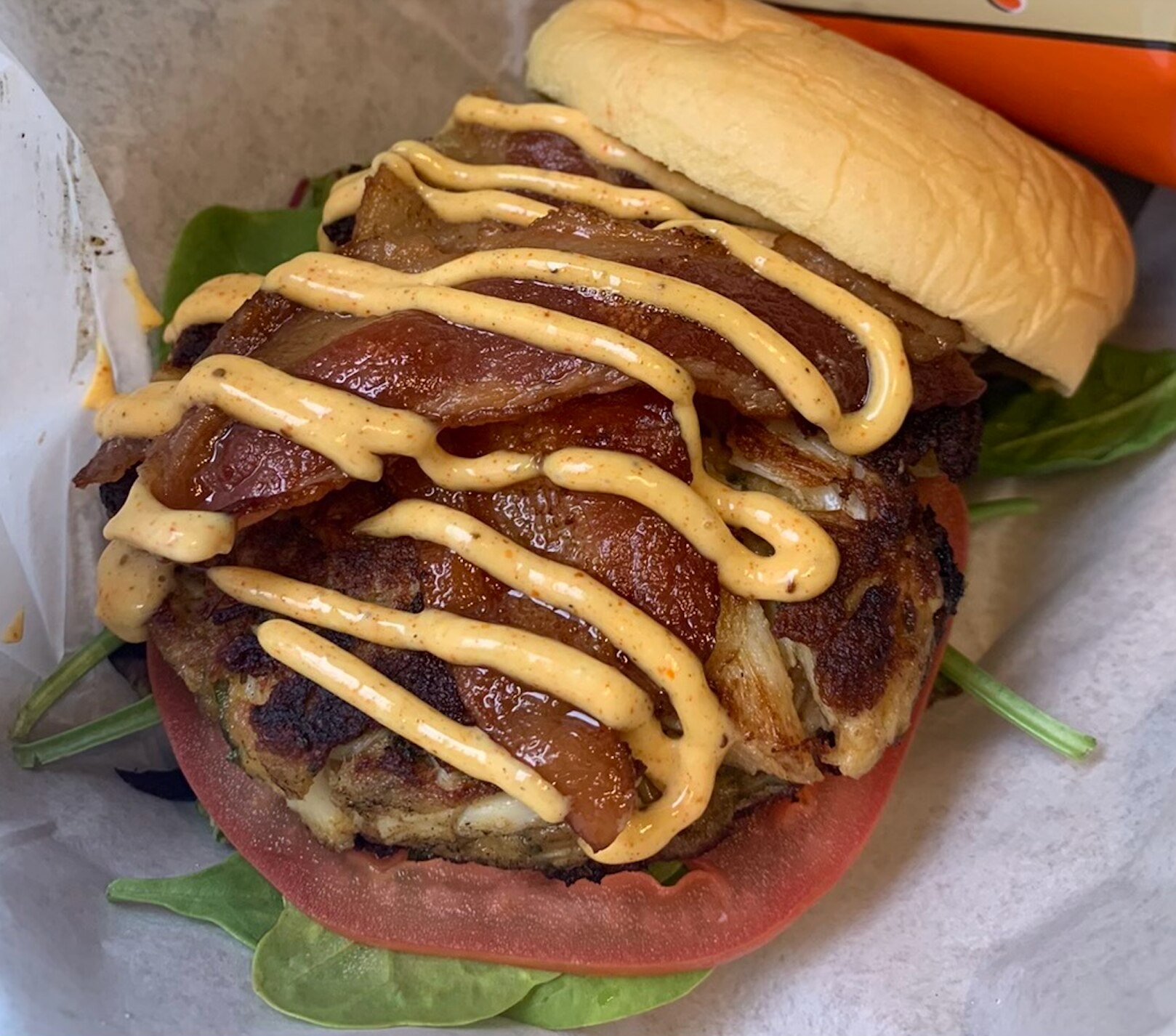 A crab cake BLT from Capt'n Crabby, which opens in Hampden this May, features mixed greens and crabby sauce.