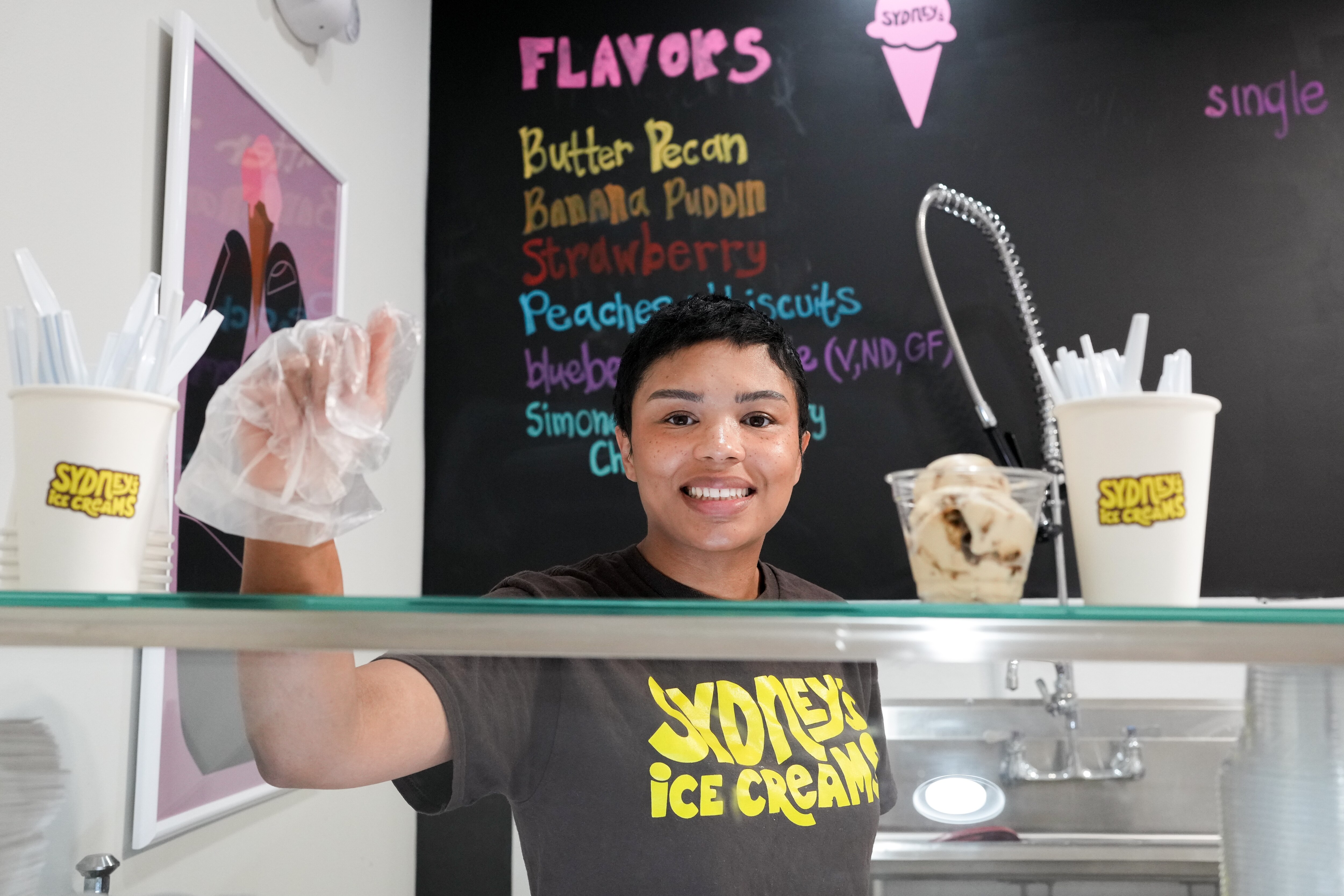 Sydney Newton, owner of Sydney’s Ice Creams, poses for a portrait behind the counter of her shop.