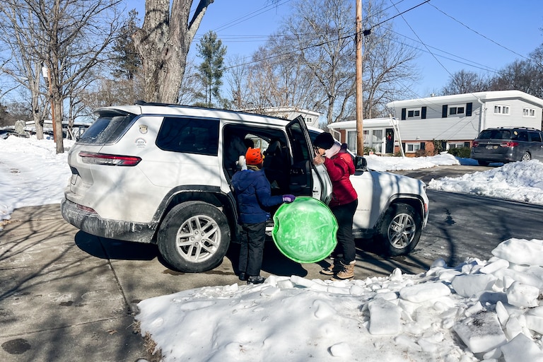 Natasha Tynes and her 8-year-old son Gabriel prepare to go sledding in Rockville. They're looking for creative ways to pass the time, with school still closed.