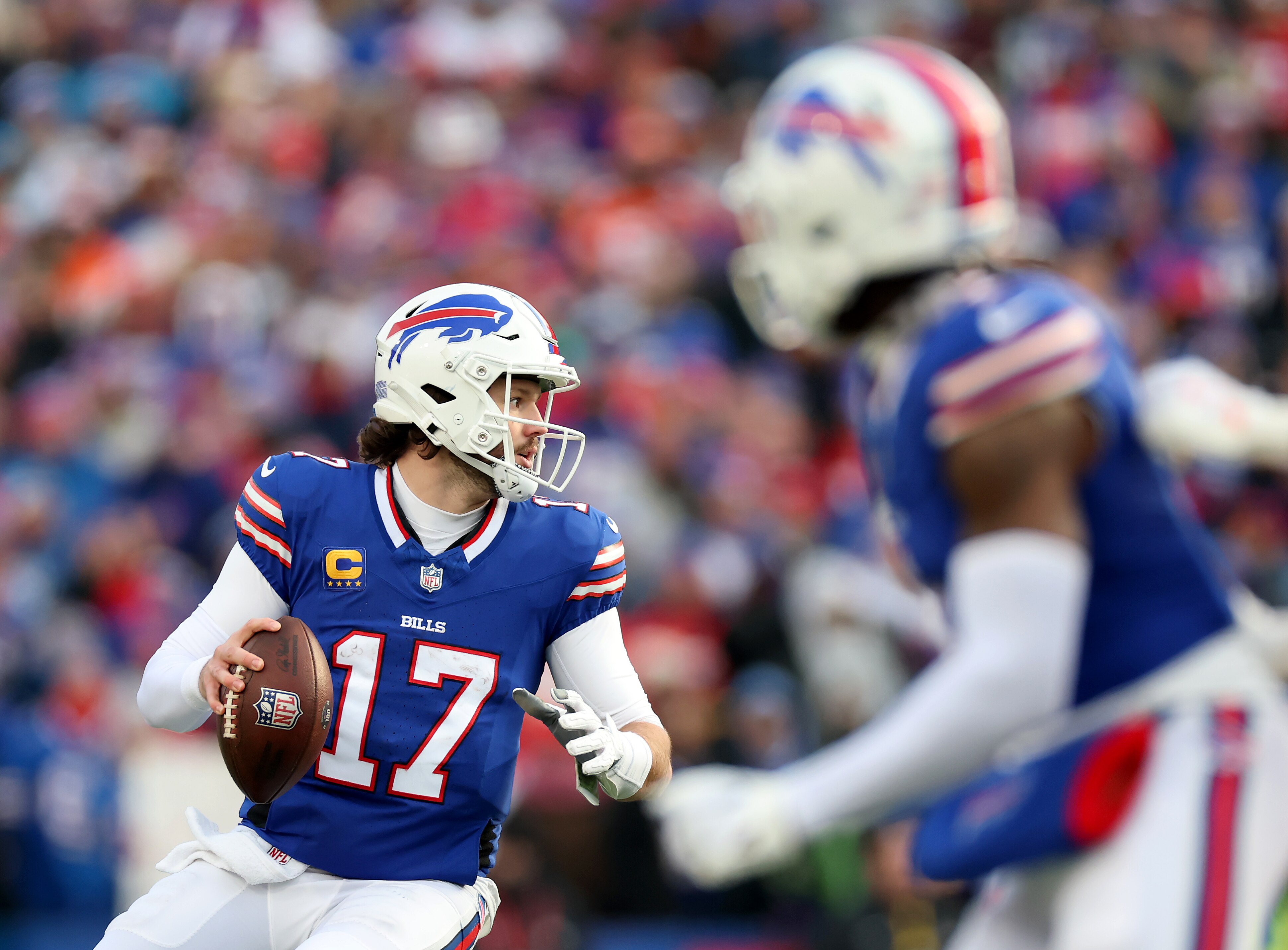 ORCHARD PARK, NEW YORK - JANUARY 12: Josh Allen #17 of the Buffalo Bills looks to pass in the third quarter against the Denver Broncos during the AFC Wild Card Playoffs at Highmark Stadium on January 12, 2025 in Orchard Park, New York.