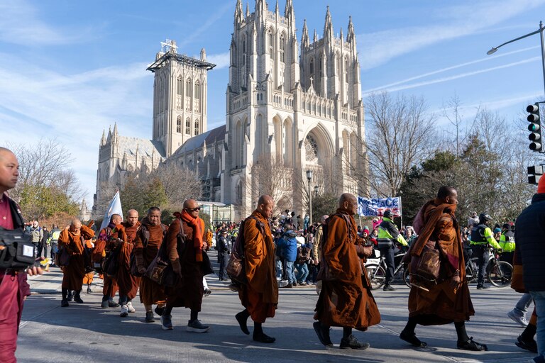 Buddhist monks walk outside of the Washington National Cathedral after and event they participated during the Walk For Peace, Tuesday, Feb. 10, 2026, in Washington.