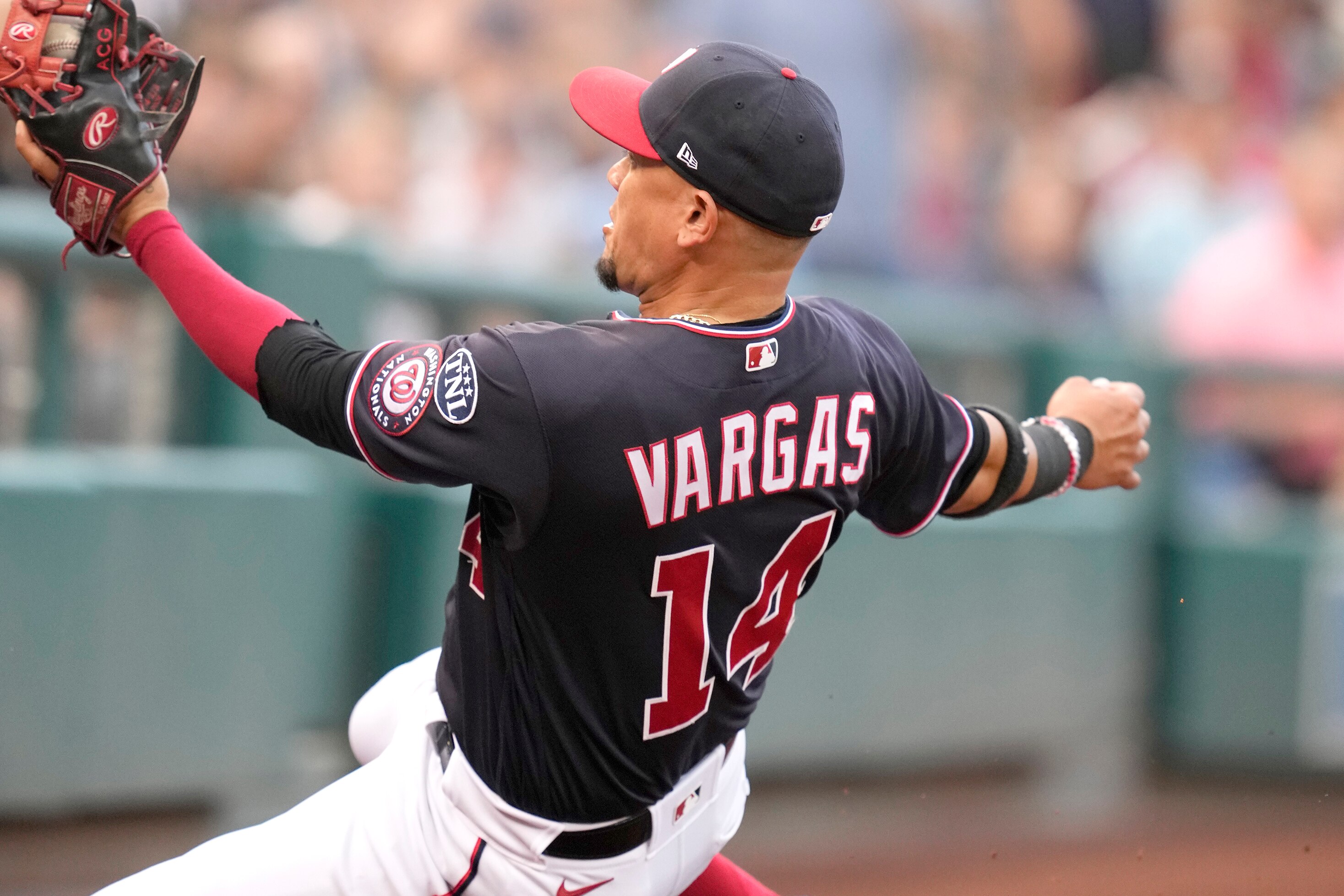 Ildemaro Vargas of the Nationals makes a sliding catch of a foul ball hit by Rafael Devers of the Red Sox in the first inning of Washington's 6-2 win Wednesday night.