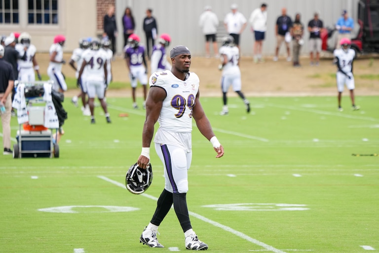 Baltimore Ravens linebacker Odafe Oweh (99) crosses a practice field to join teammates during the team’s training camp at the Under Armour Performance Center in Owings Mills, Md. on Tuesday, August 19, 2025.