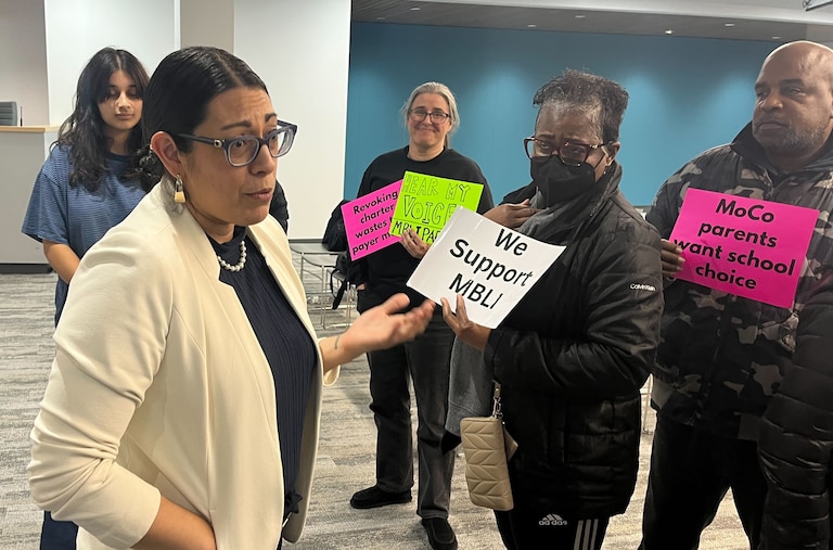 MECCA Business Learning Institute parents talk with school board member Rita Montoya about their desire to keep the charter school open on Thursday, Jan. 22, 2026.