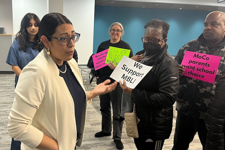 MECCA Business Learning Institute parents talk with school board member Rita Montoya about their desire to keep the charter school open on Thursday, Jan. 22, 2026.