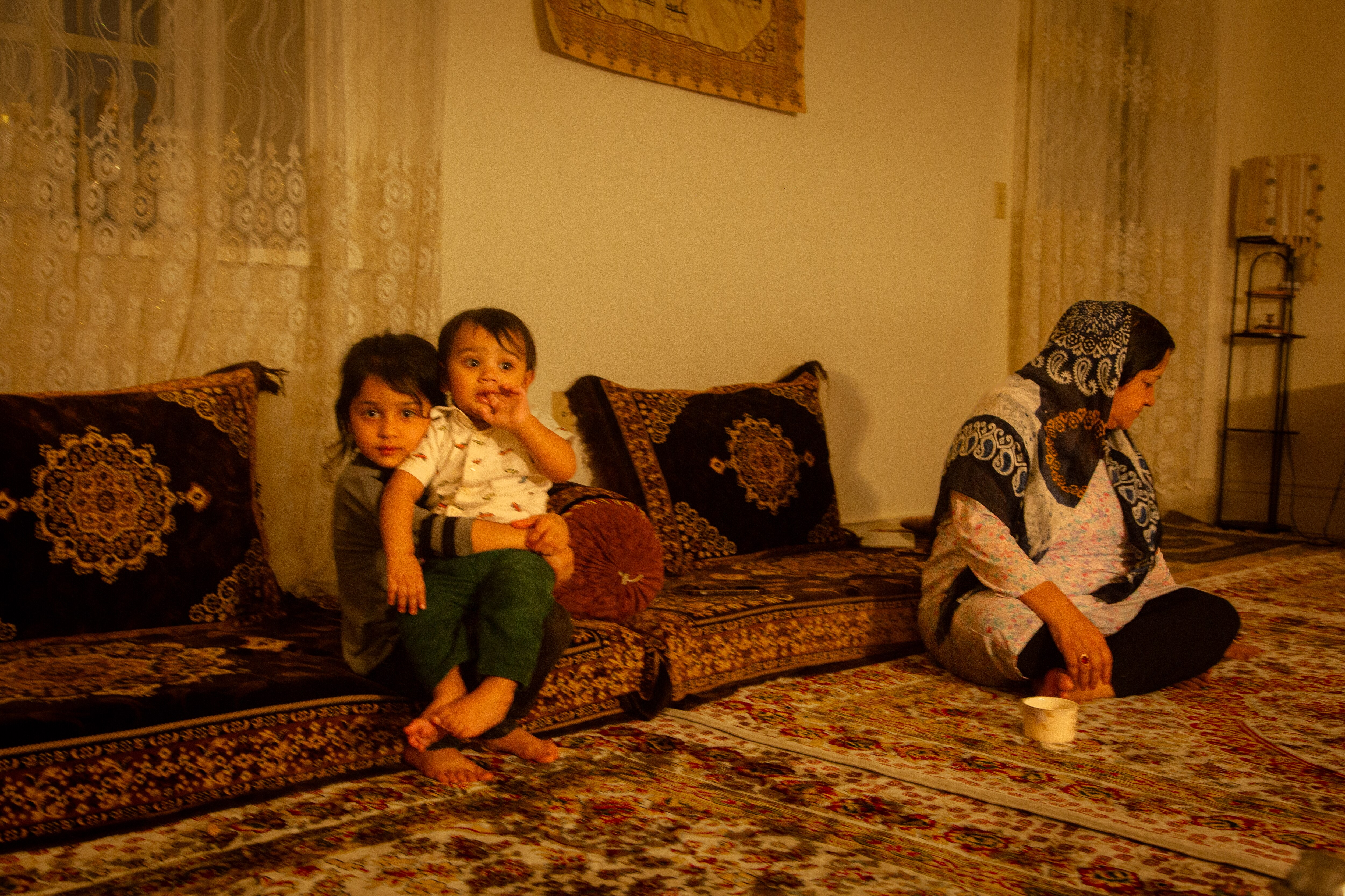 Nazifa, an Afghan refugee, spends time with her young grandchildren at her family's Baltimore apartment. While Nazifa says she appreciates the opportunities in the U.S., she has been surprised by the degree of crime and other city problems.