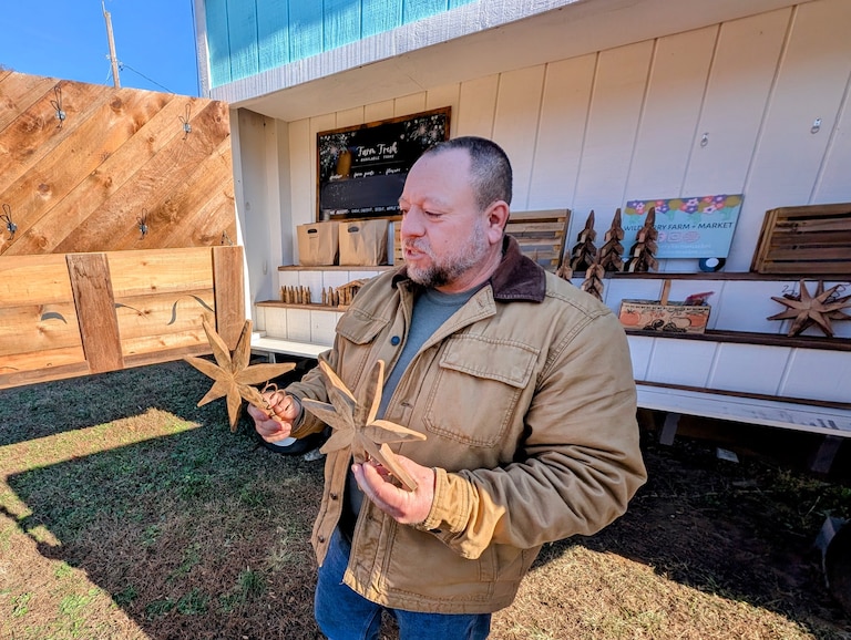 Matt Jones shows off Christmas ornaments made from old tobacco drying sticks, sold at his family's Wildberry Farm as part of the Jul På Gården collection.