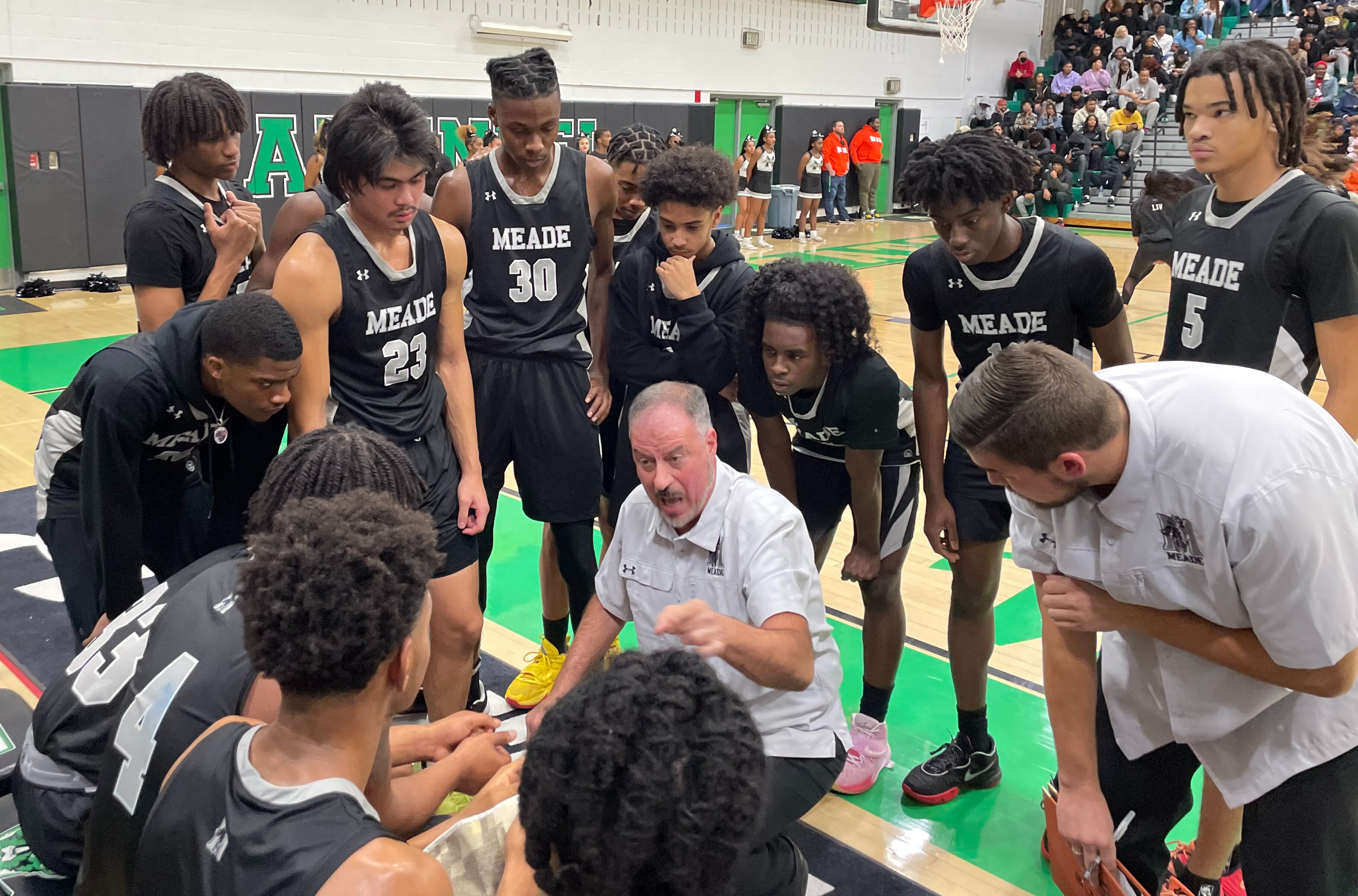 Meade basketball coach Mike Glick talks strategy with his team during Friday evening's Anne Arundel County boys contest with Arundel. The No. 9 Mustangs improved to 4-0 with a hard fought 84-78 victory in Gambrills.