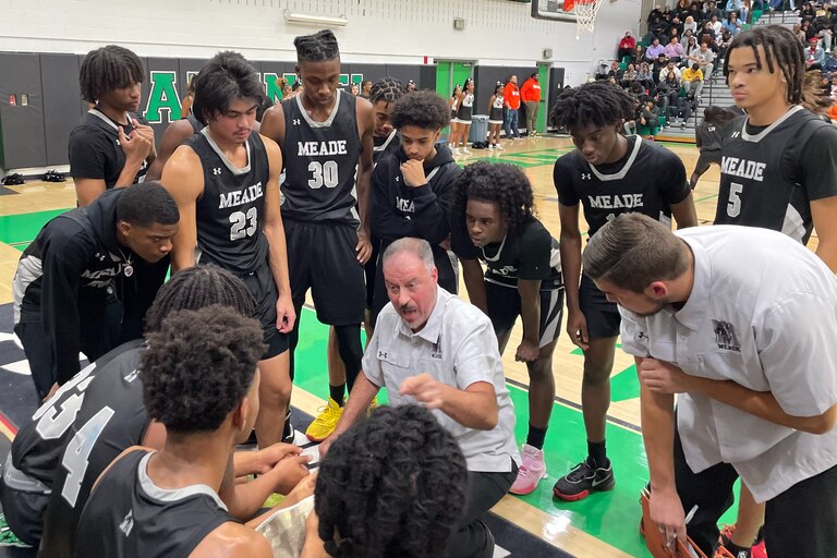 Meade basketball coach Mike Glick talks strategy with his team during Friday evening's Anne Arundel County boys contest with Arundel. The No. 9 Mustangs improved to 4-0 with a hard fought 84-78 victory in Gambrills.
