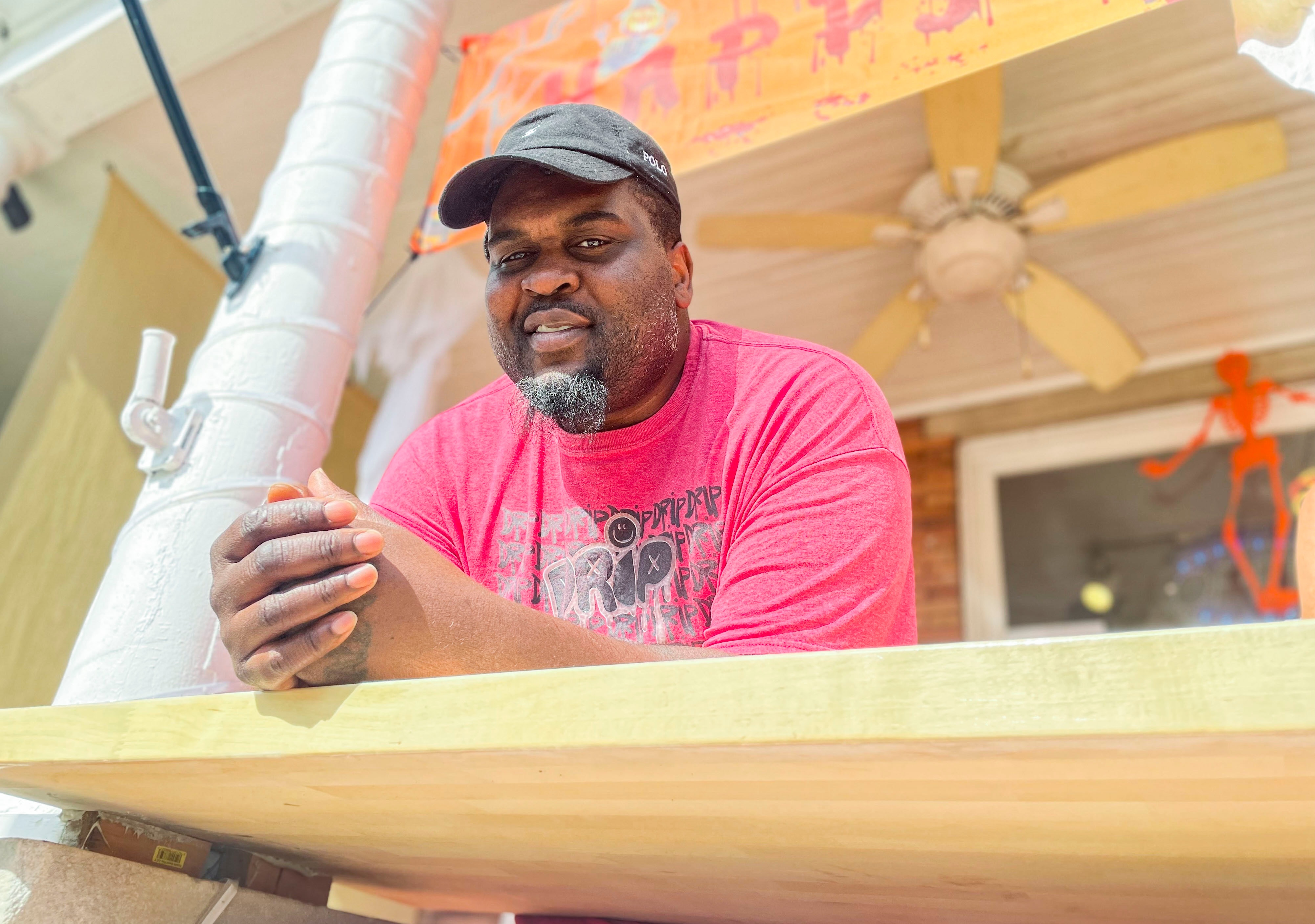 Andre Greer of Hot Dog Central stands outside his restaurant on W. 36th Street in Hampden.