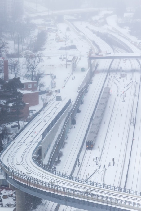 A red line Metro train arrives on Sunday, Jan. 25, 2026, during a snowstorm in Silver Spring, Md. at the Silver Spring Metro Center.