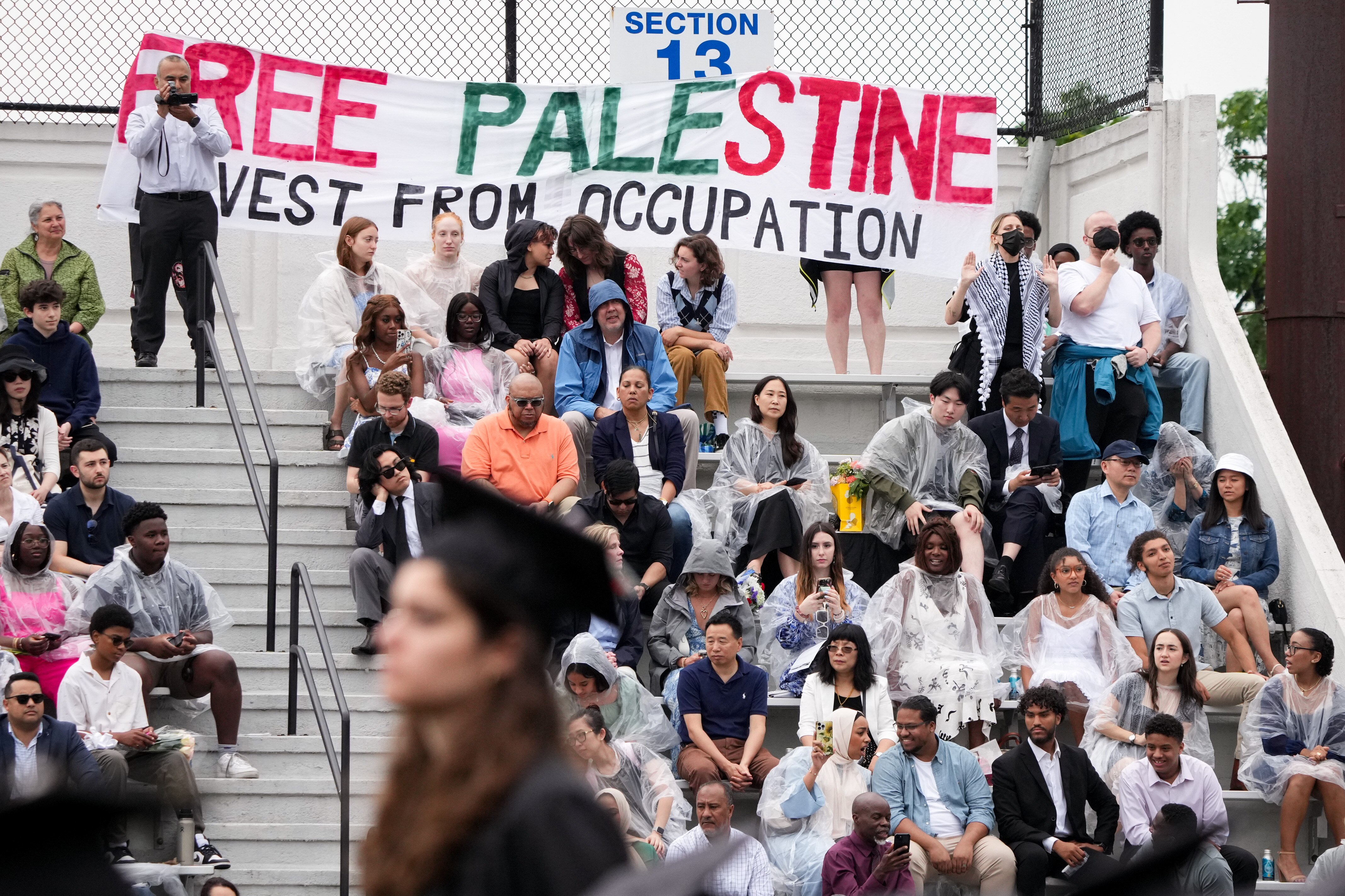 As some students turned their backs on speaker Mitt Romney, pro-Palestine demonstrators in the audience called for Johns Hopkins to divest from Israel at the university’s commencement ceremony last spring.