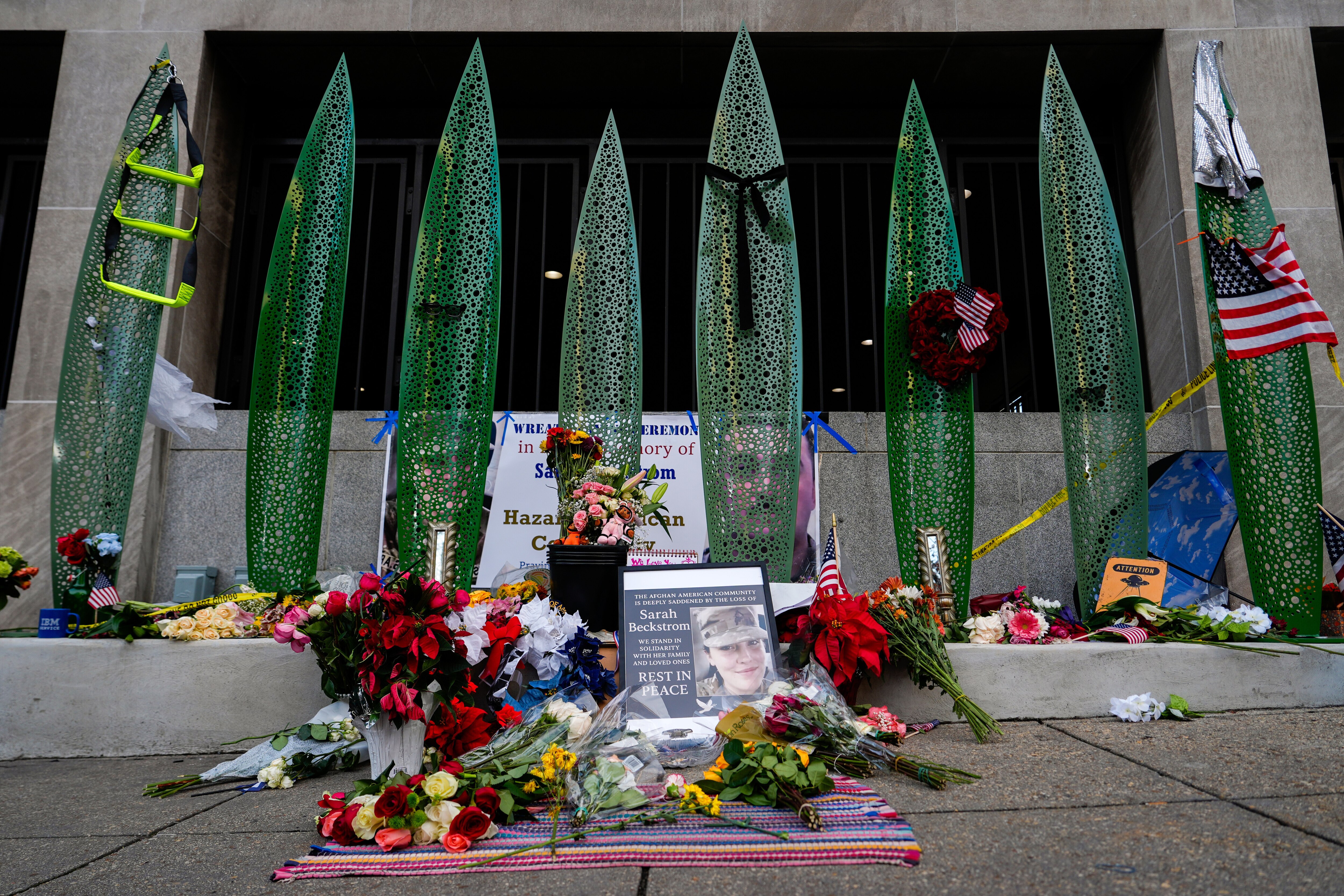 A makeshift memorial for U.S. Army Spc. Sarah Beckstrom and U.S. Air Force Staff Sgt. Andrew Wolfe is seen outside of Farragut West Station, near the site where the two National Guard members were shot, Monday, Dec. 1, 2025, in Washington. (AP Photo/Julia Demaree Nikhinson)