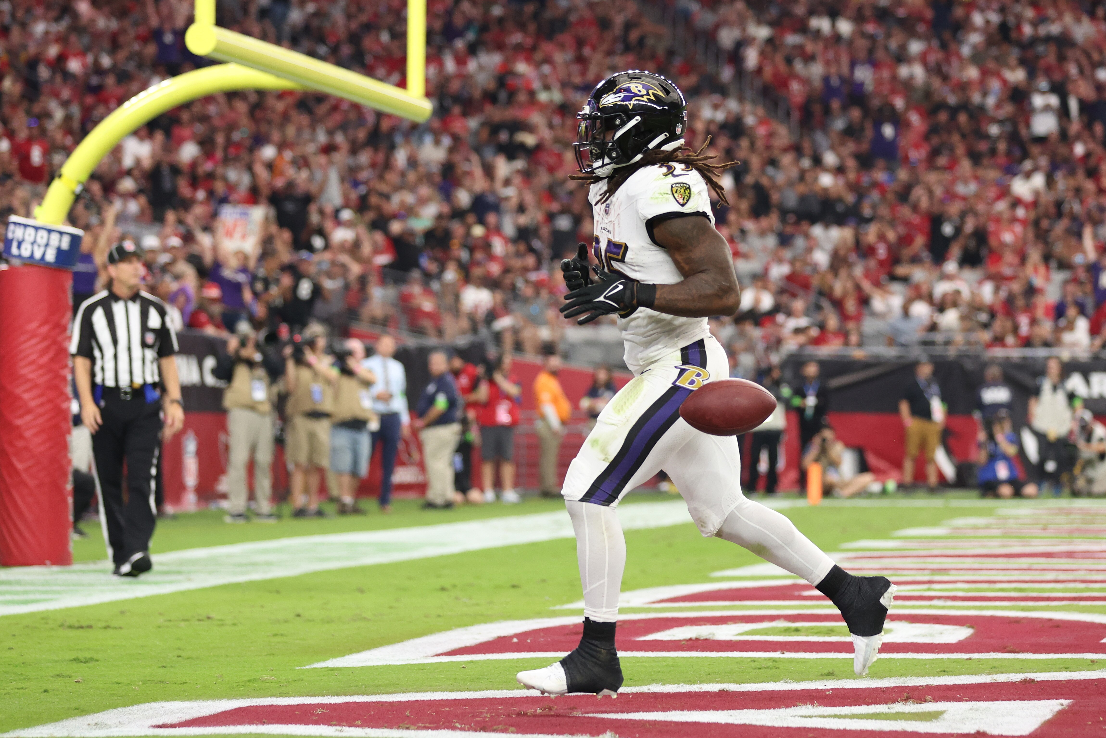 Gus Edwards scores one of his three touchdowns Sunday in the Ravens' 31-24 win at Arizona.