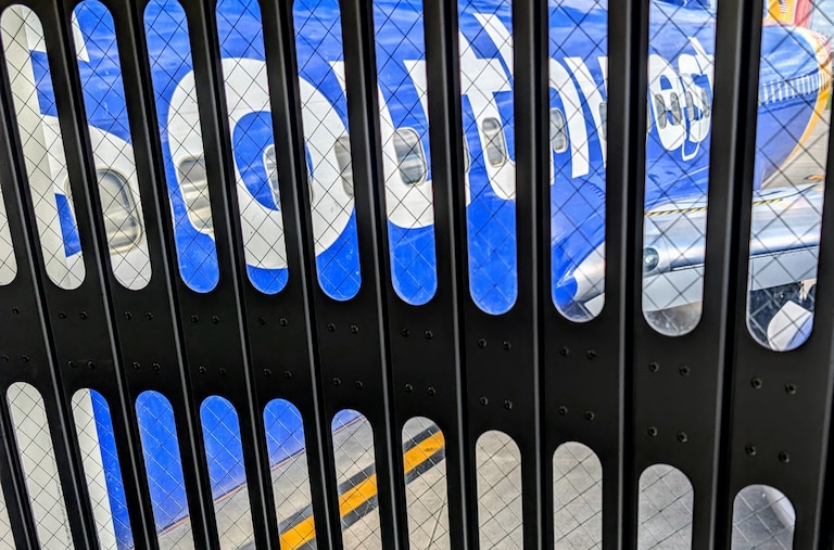 A Southwest Airlines flight sits next to the passenger gate on April 19, 2026 as passengers in Louisville, Kentucky, board for a flight to Baltimore-Washington International Airport.