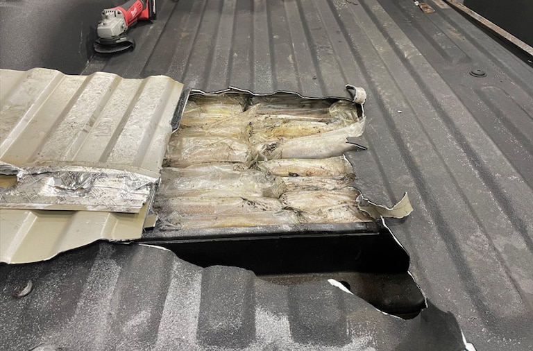 Approximately 83 kg of suspected cocaine seized from a concealed location within a flatbed truck, discovered during a traffic stop.