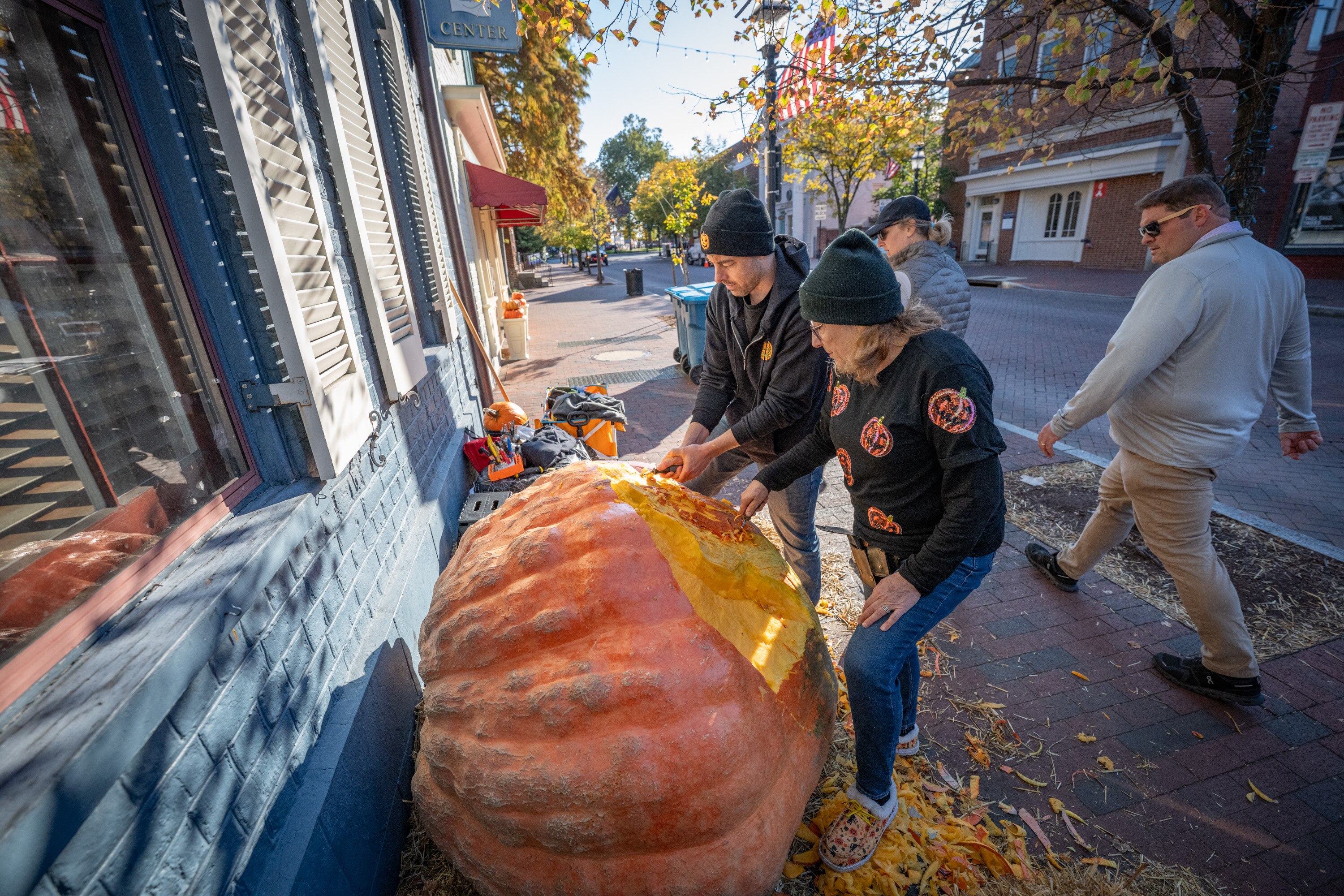 Artist Nancy Baker carves an 1100-pound pumpkin with help from her son, Nick Baker, during the Great Annapolis Pumpkins event in downtown Annapolis. 