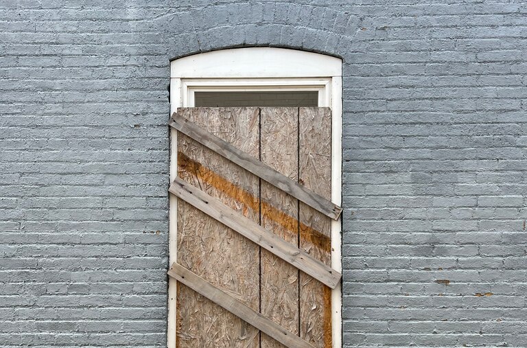A boarded-up side window of a vacant home in the Easterwood neighborhood that is owned by an ABC Capital investor.