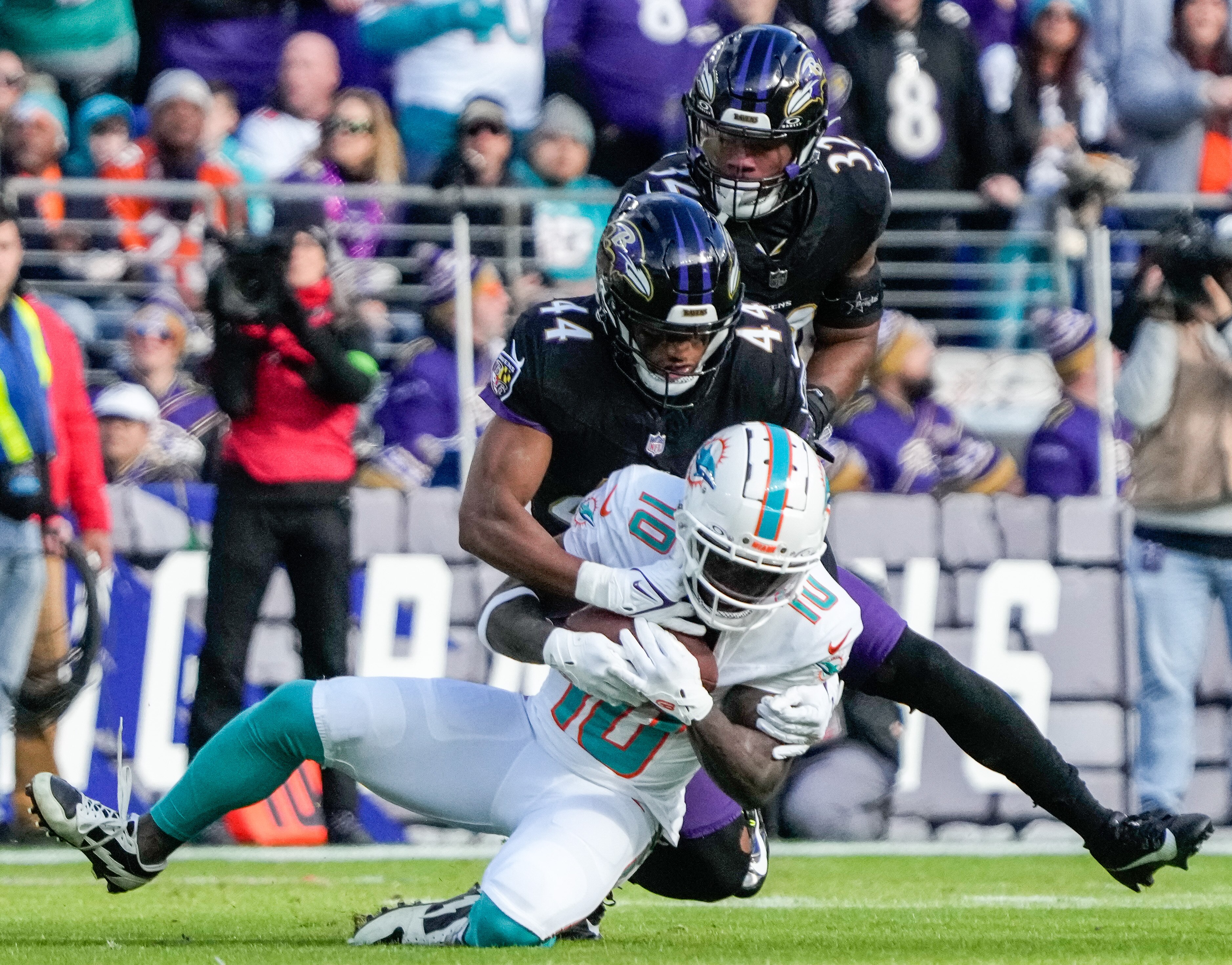 Ravens cornerback Marlon Humphrey tackles Miami Dolphins wide receiver Tyreek Hill during the game on New Year's Eve.