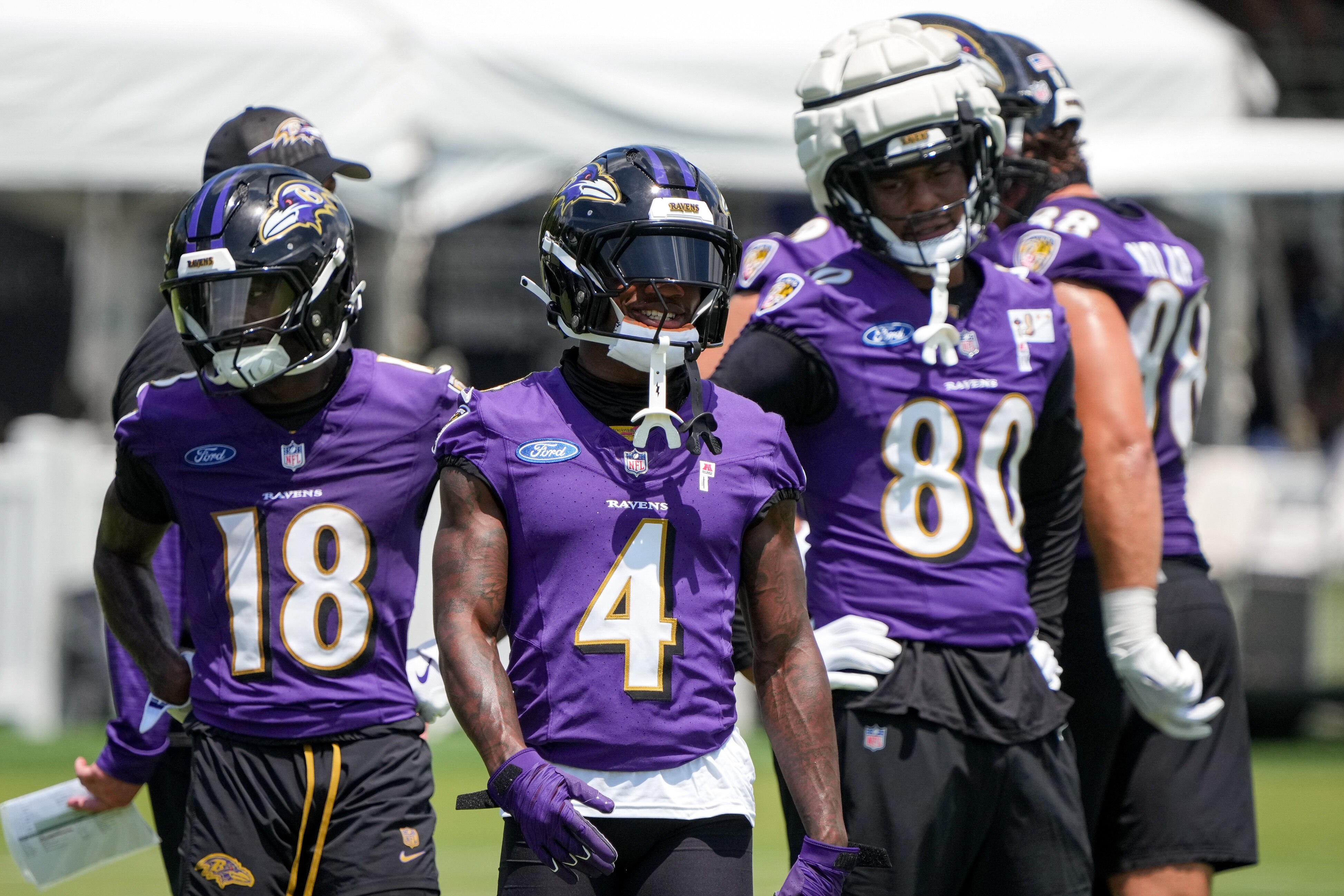Ravens wide receivers Zay Flowers (4) and Dayton Wade (18) and tight end Isaiah Likely line up for a drill during practice Sunday in Owings Mills.
