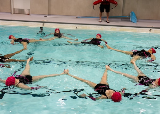 Thursday, April 16, 2026, in Baltimore — The Fluid Movement synchronized swimming group performs a routine at the new pool during the grand reopening of the historic Chick Webb Memorial Recreation Center in East Baltimore.