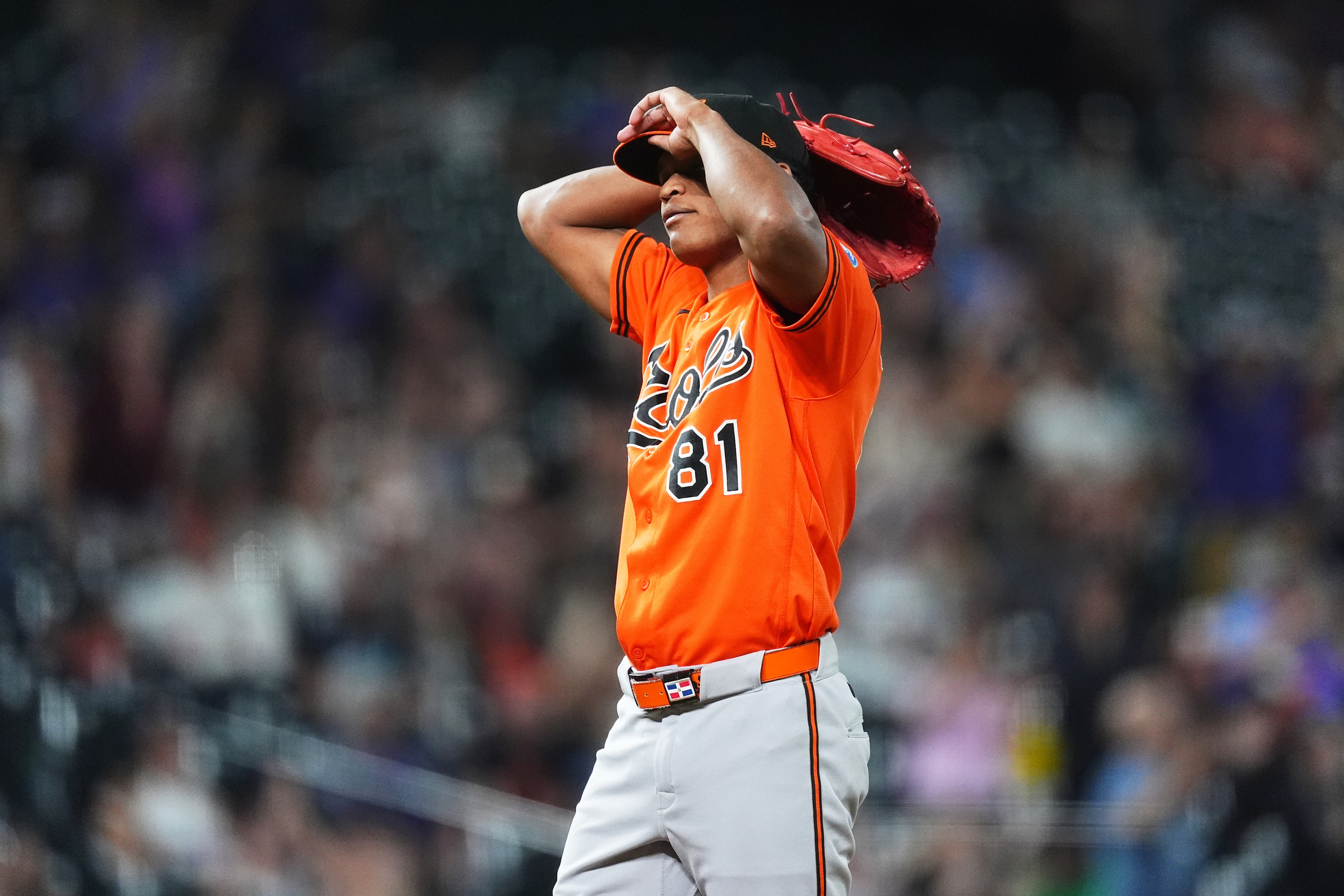 Orioles relief pitcher Luis De León reacts after giving up a two-run home run to Colorado Rockies first baseman TJ Rumfield in the seventh inning.