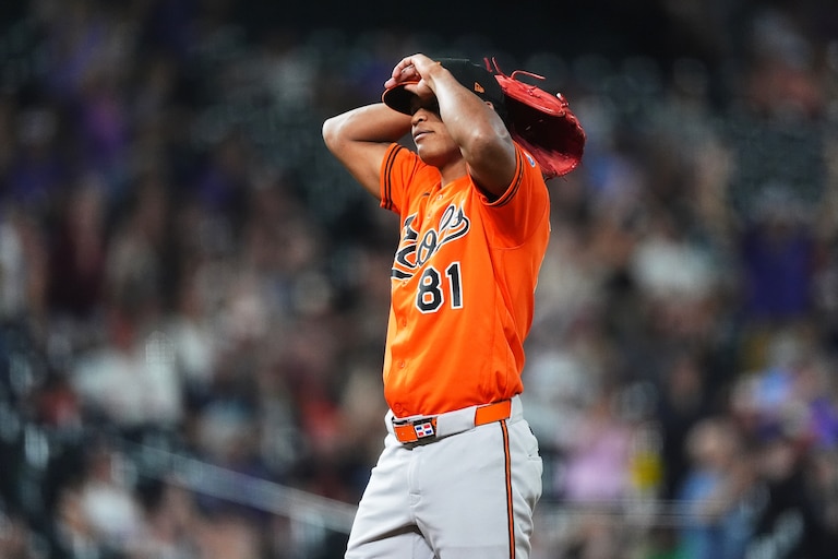 Orioles relief pitcher Luis De León reacts after giving up a two-run home run to Colorado Rockies first baseman TJ Rumfield in the seventh inning.