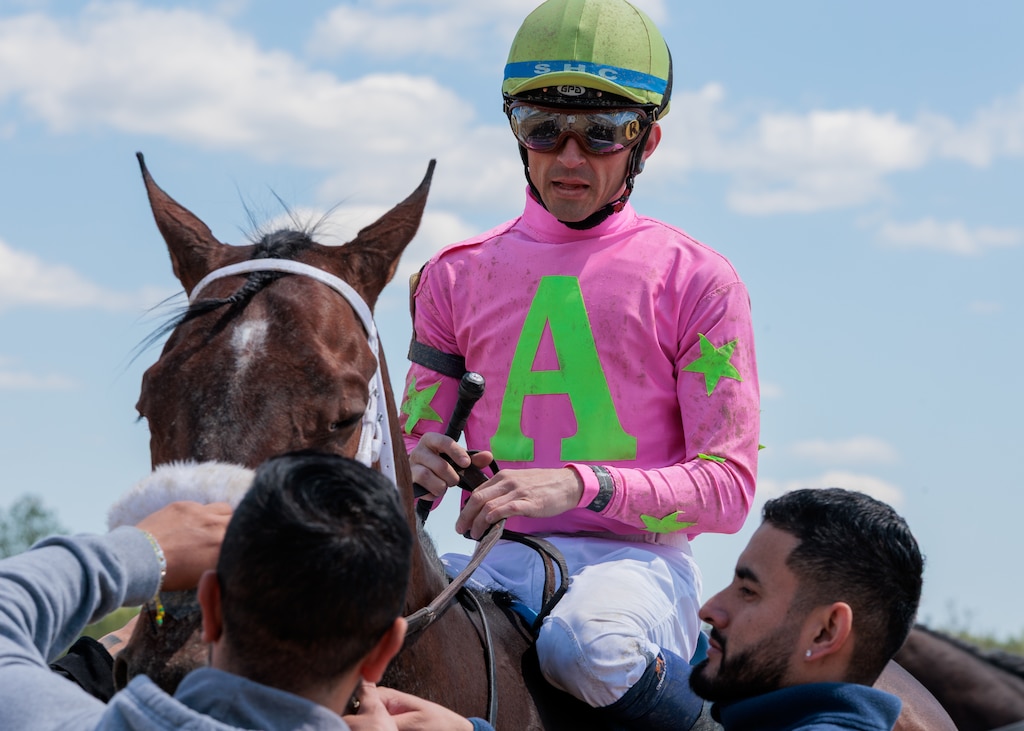 Sheldon Russell on horse Prado Road after a race at Laurel Park racetrack.