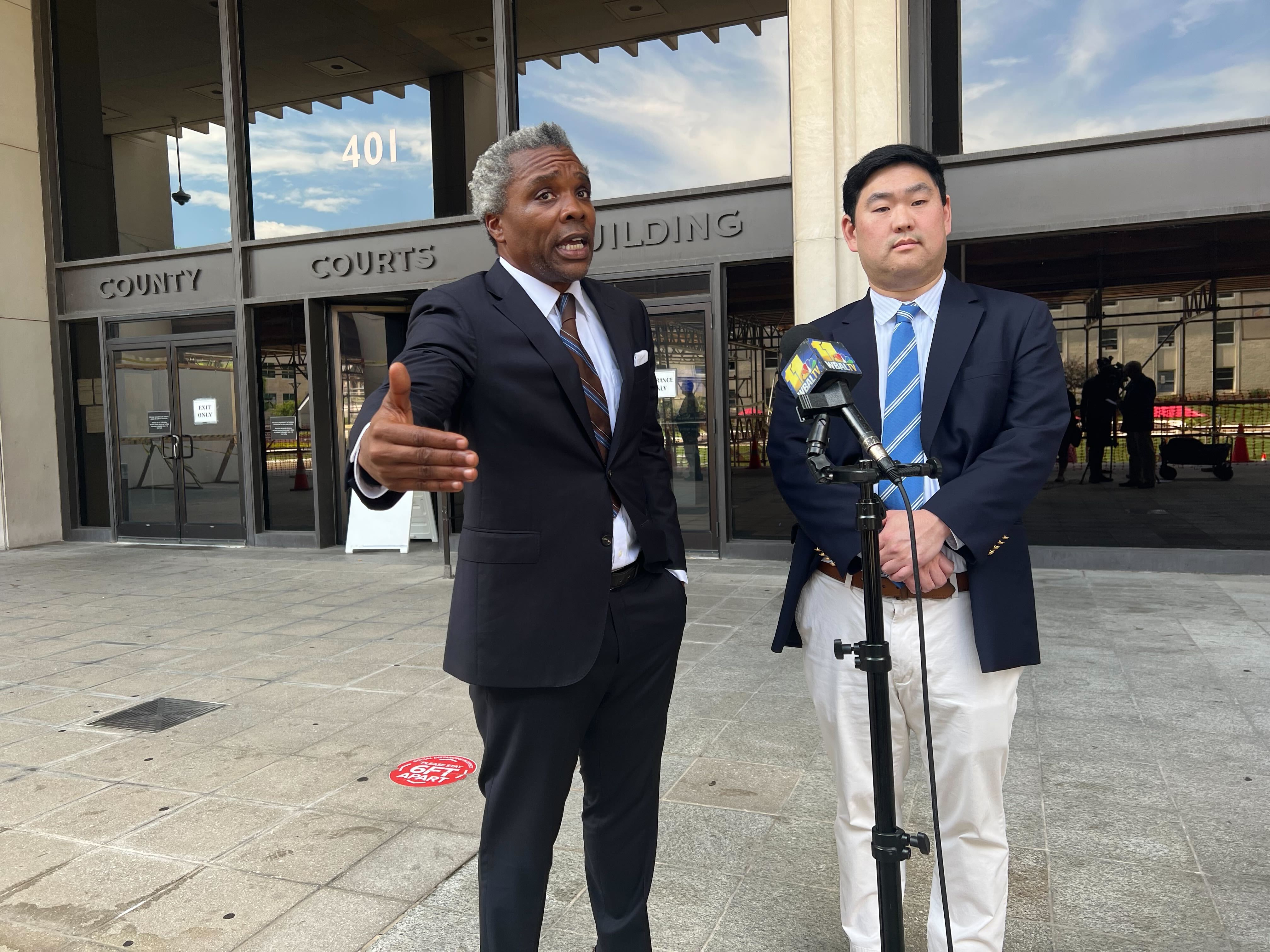Christopher Bendann, right, and his attorney Kobie Flowers speak following a hearing Tuesday in which a judge set a new trial date for the ex-Gilman School teacher who is charged with sexually abusing a student.