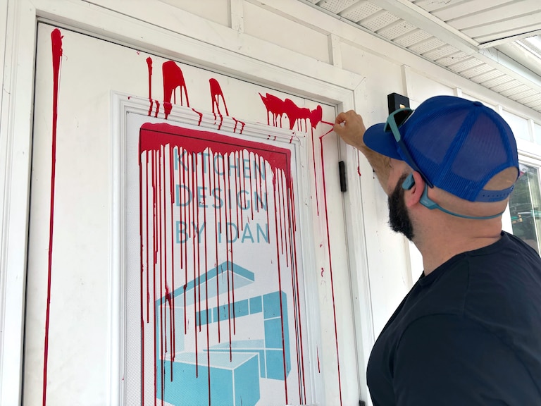 Kitchen Design by Idan, on Falls Rd in East Baltimore county near the city line was vandalized at 11:58pm Wednesday night. Business owner Idan Tzameret uses a knife to peel off the spray paint.