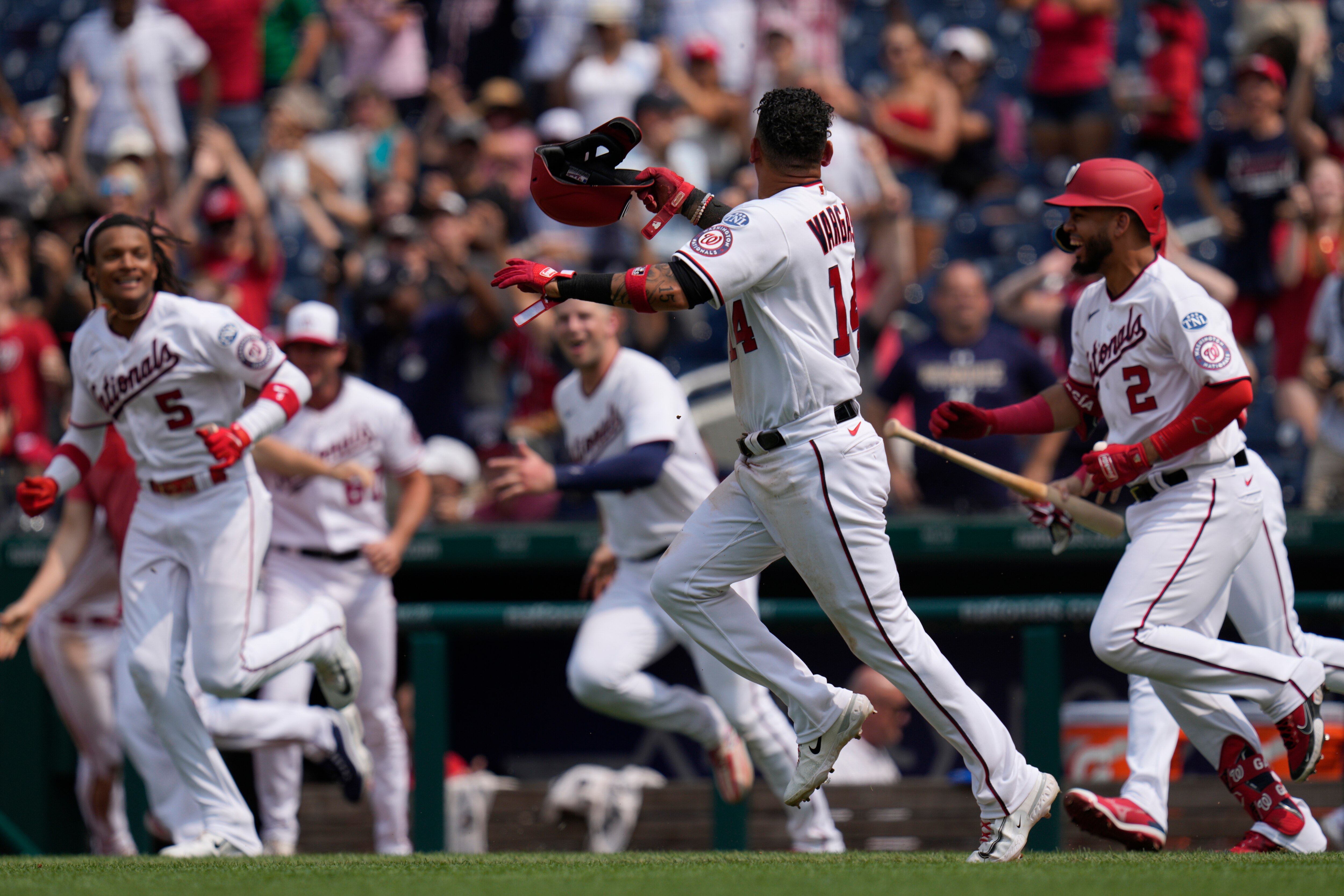 Teammates chase Ildemaro Vargas after he scored the game-winning run as the Nationals beat the Brewers 3-2 on Wednesday.