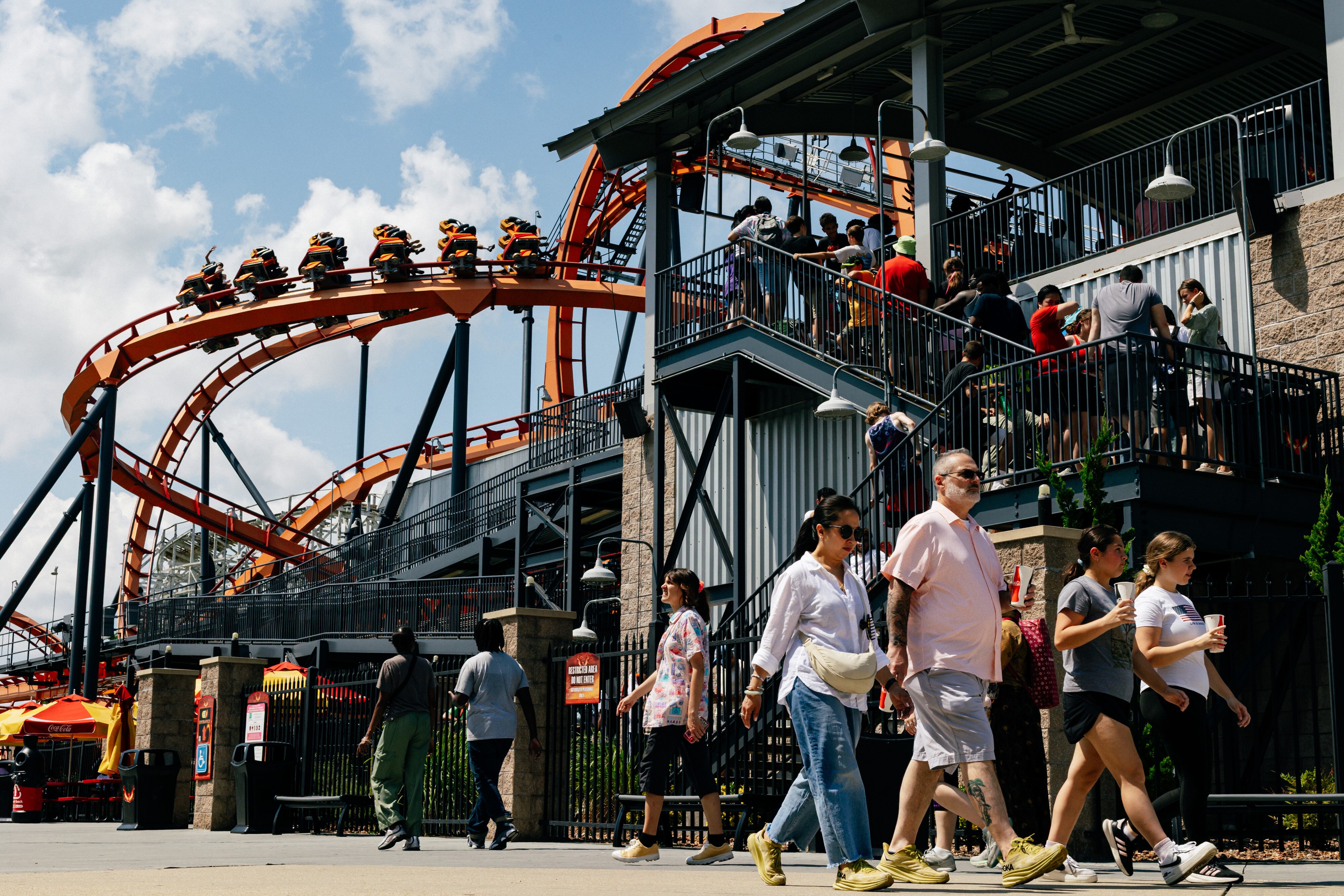 Visitors line up for the Firebird rollercoaster, which reaches a top sped of 56 mph, at Six Flags America in Bowie, MD on Saturday, Aug. 16, 2025. The amusement park will close permanently at the end of the 2025 season.