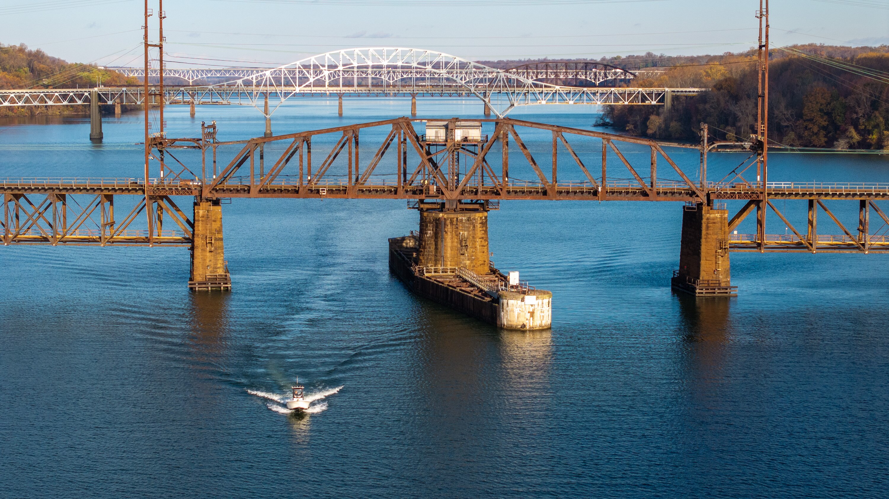 A boater passes under the Amtrak bridge over the Susquehanna River, downriver from where AquaCon plans to build an indoor salmon farm in Cecil County. 
