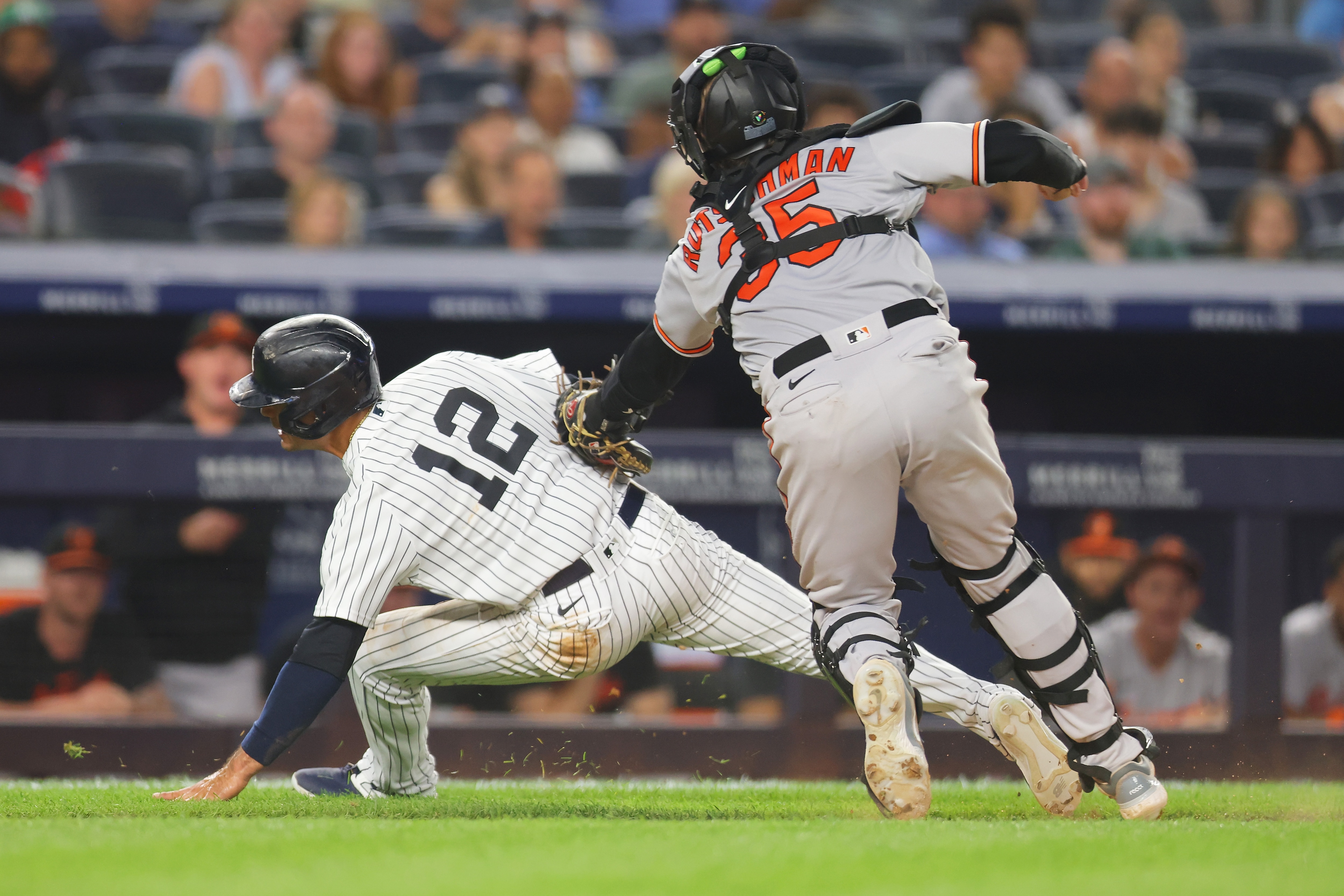 Isiah Kiner-Falefa #12 of the New York Yankees is tagged out by Adley Rutschman #35 of the Baltimore Orioles trying to score on a ground ball to the pitcher by DJ LeMahieu #26 in the seventh inning at Yankee Stadium on July 3, 2023 in the Bronx borough of New York City.